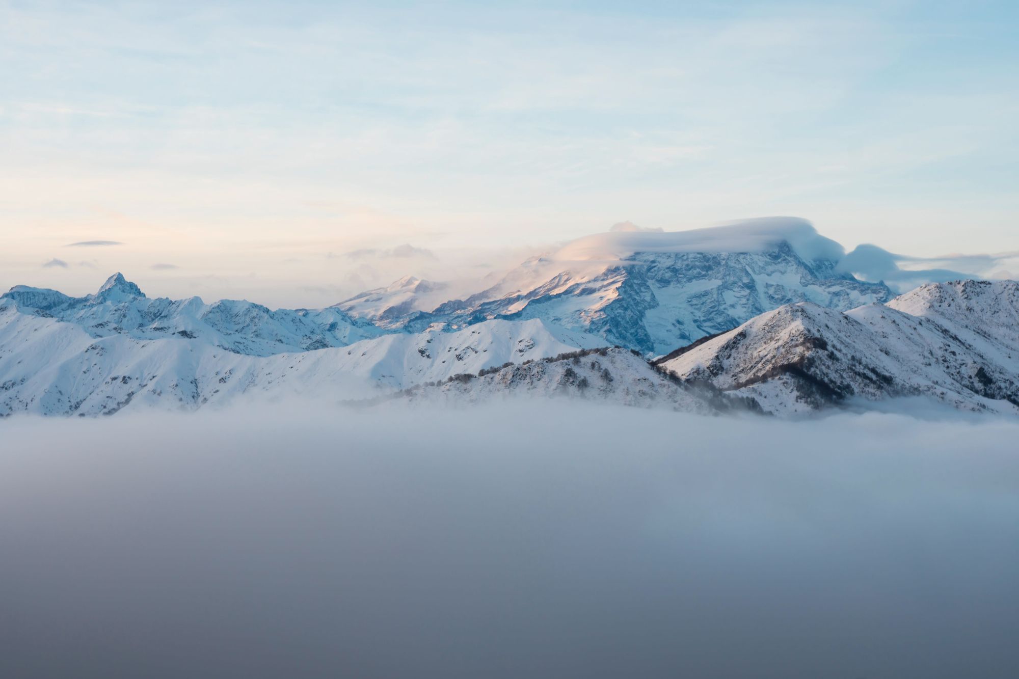 A winter panorama of the Italian Alps: Monte Rosa massif seen from the Biella pre-Alps. At sunset the fog rises from the valley bottom. Photo: Getty