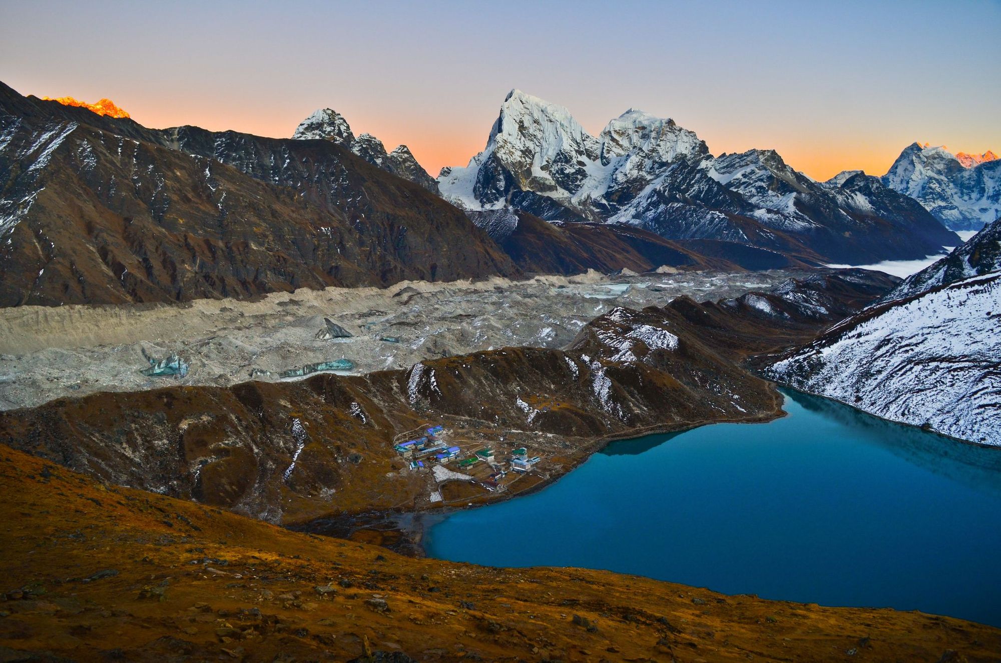 Dusk falls on Gokyo Village, the lake, and Ngozumpa Glacier. Photo: Getty.