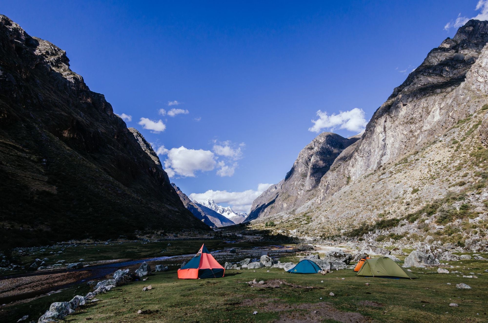 A campsite in Peru's Cordillera Blanca, surrounded by mountains.