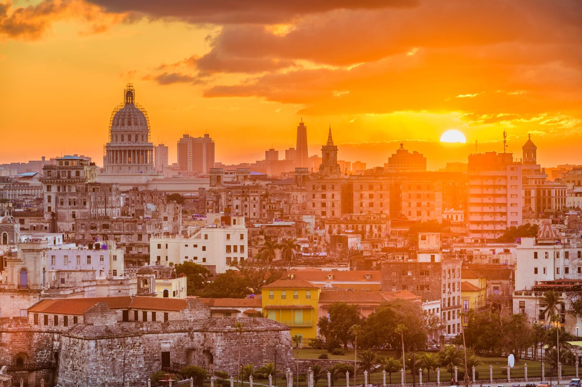 The sun sets over the layering buildings of Havana, the captivating capital of Cuba. Photo: Getty