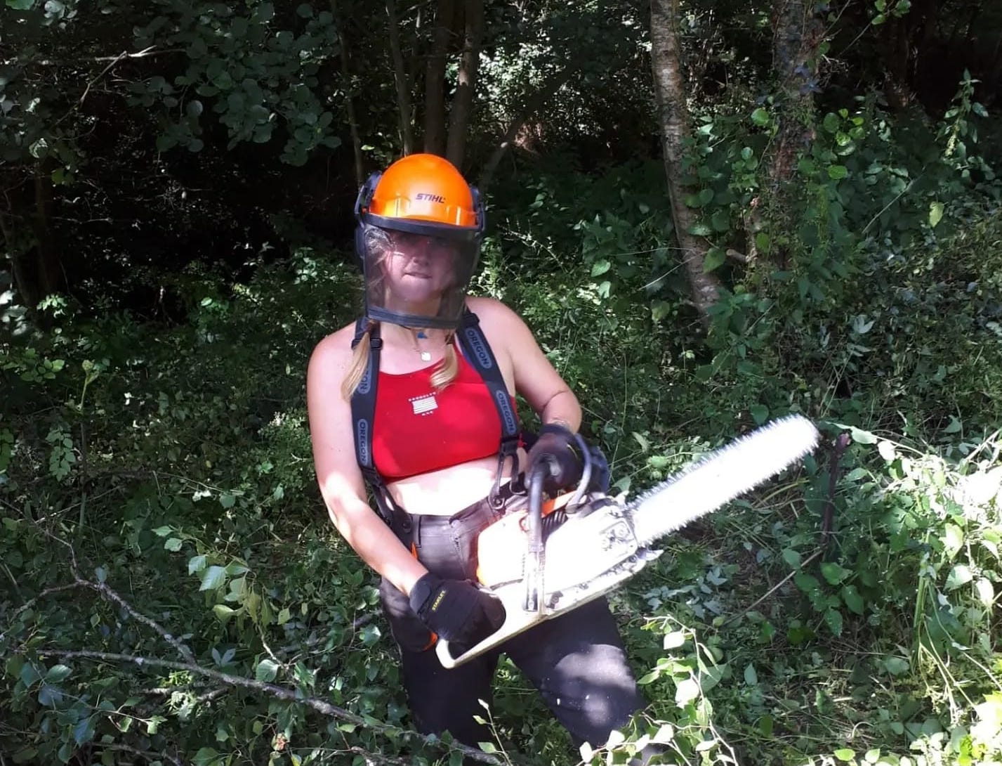 Lauren Youngs, using a chainsaw.