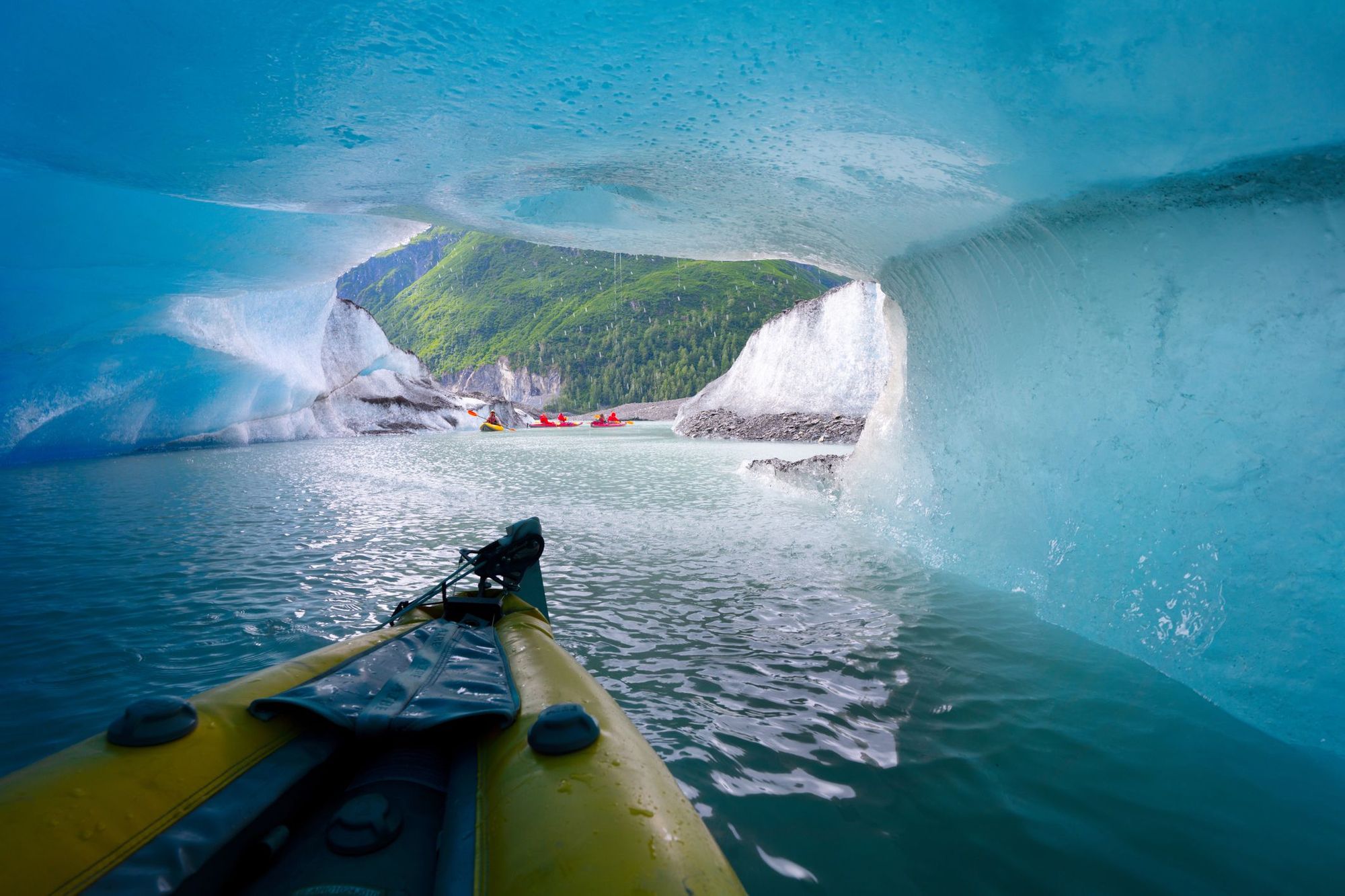 Kayaking through an ice tunnel in Alaska
