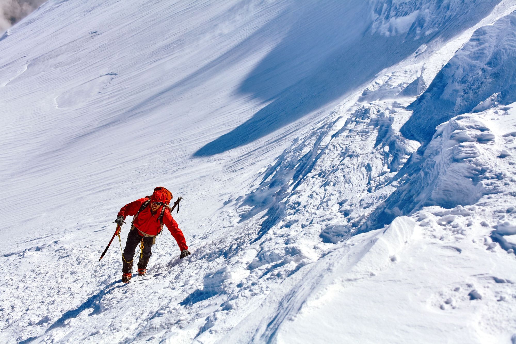 A man climbs to the top of Mount Kazbek.