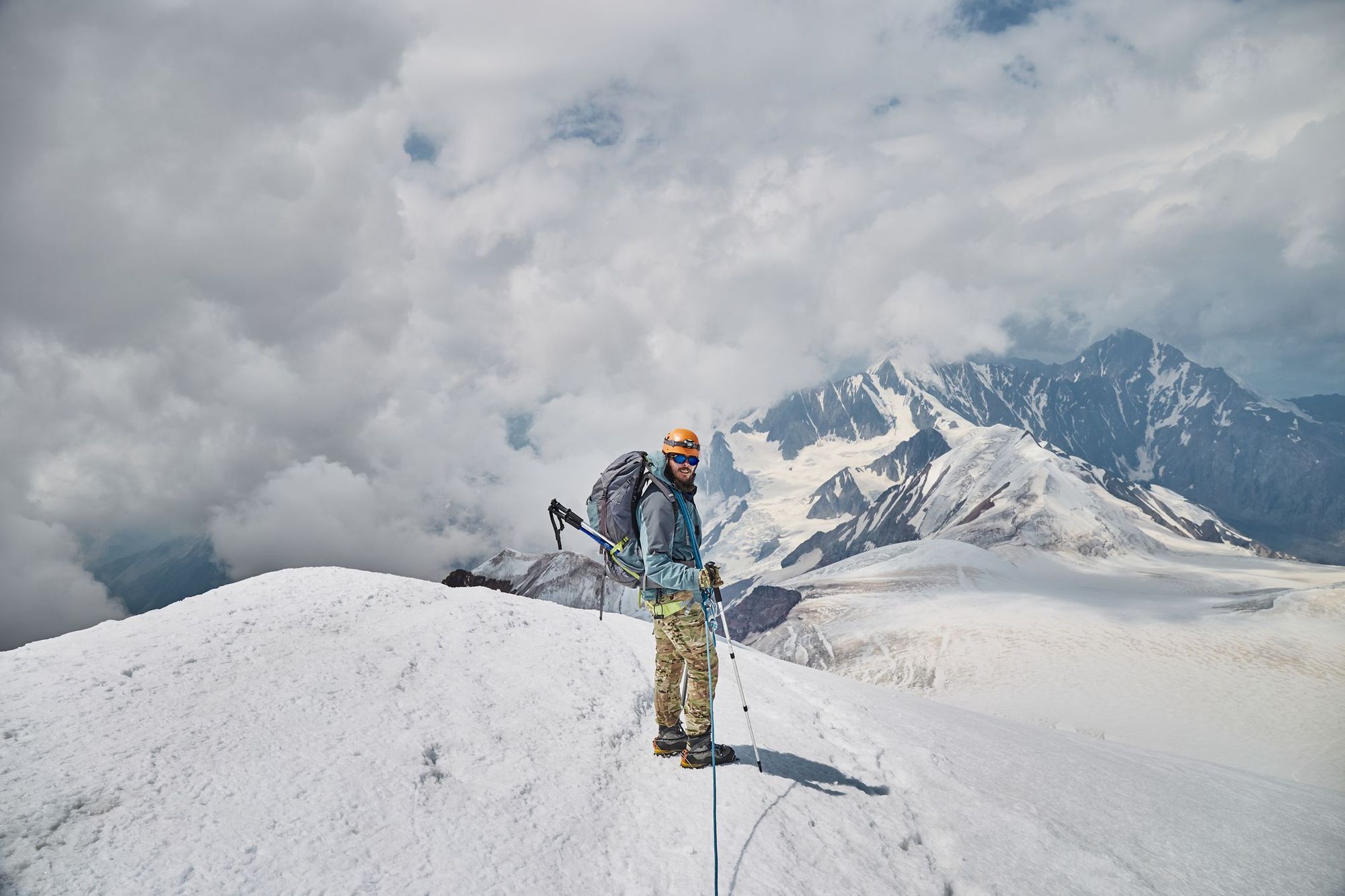 A man stands on the summit of Mount Kazbek.