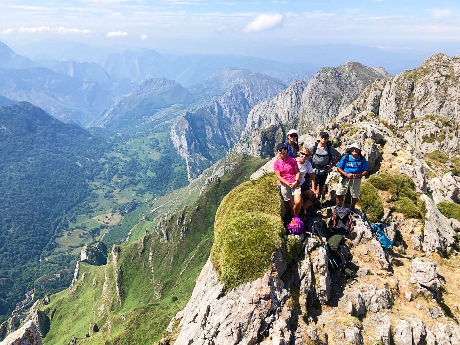 Hikers pose on top of a mountain in the Picos de Europa.