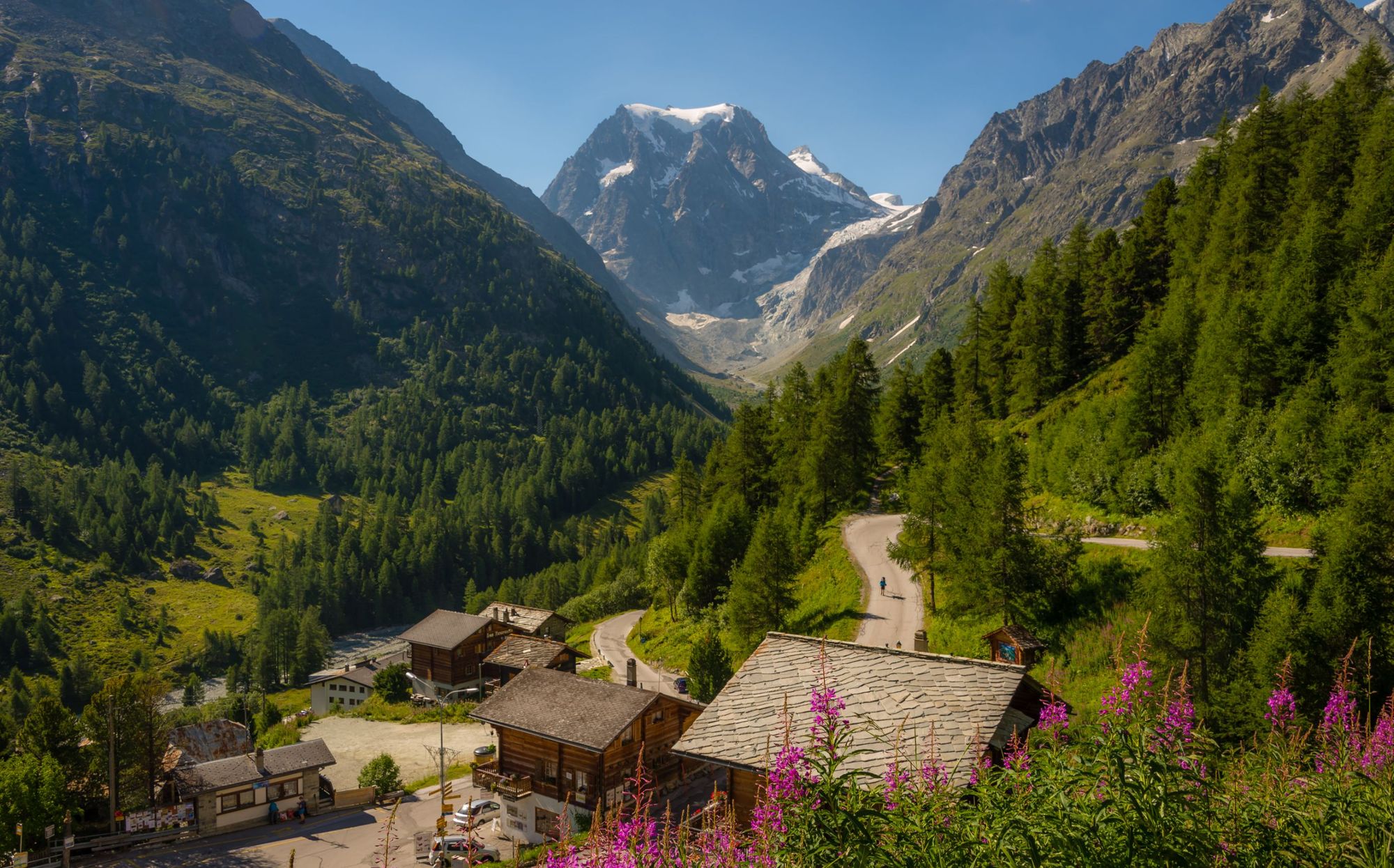 The town of Arolla, covered in green and backdropped by the snowy mountains. Photo: Getty