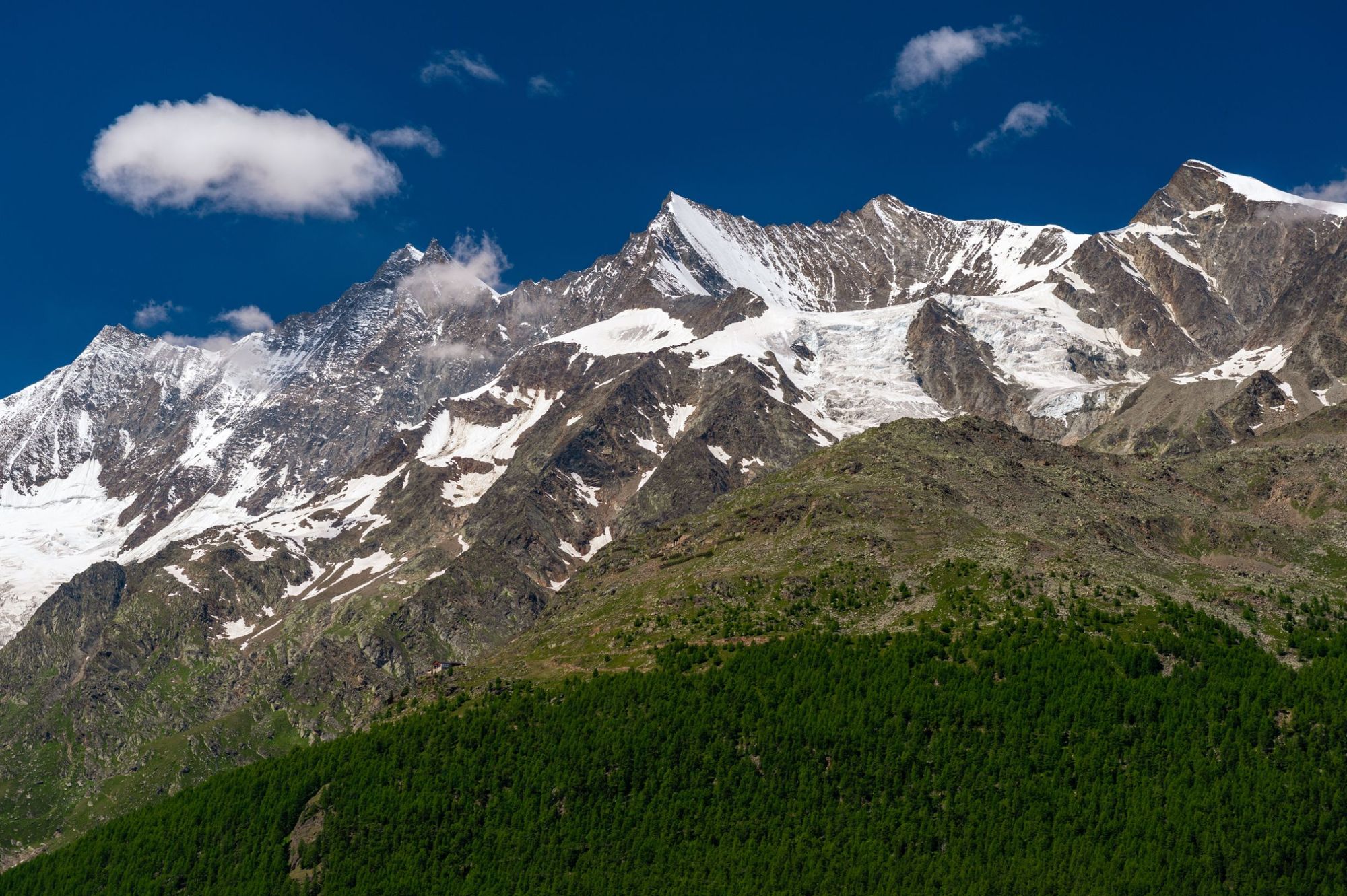 The line up of Täschhorn, Dom, Lenzspitze and Nadelhorn (above the glacier) viewed from Valais, Switzerland. Photo: Getty