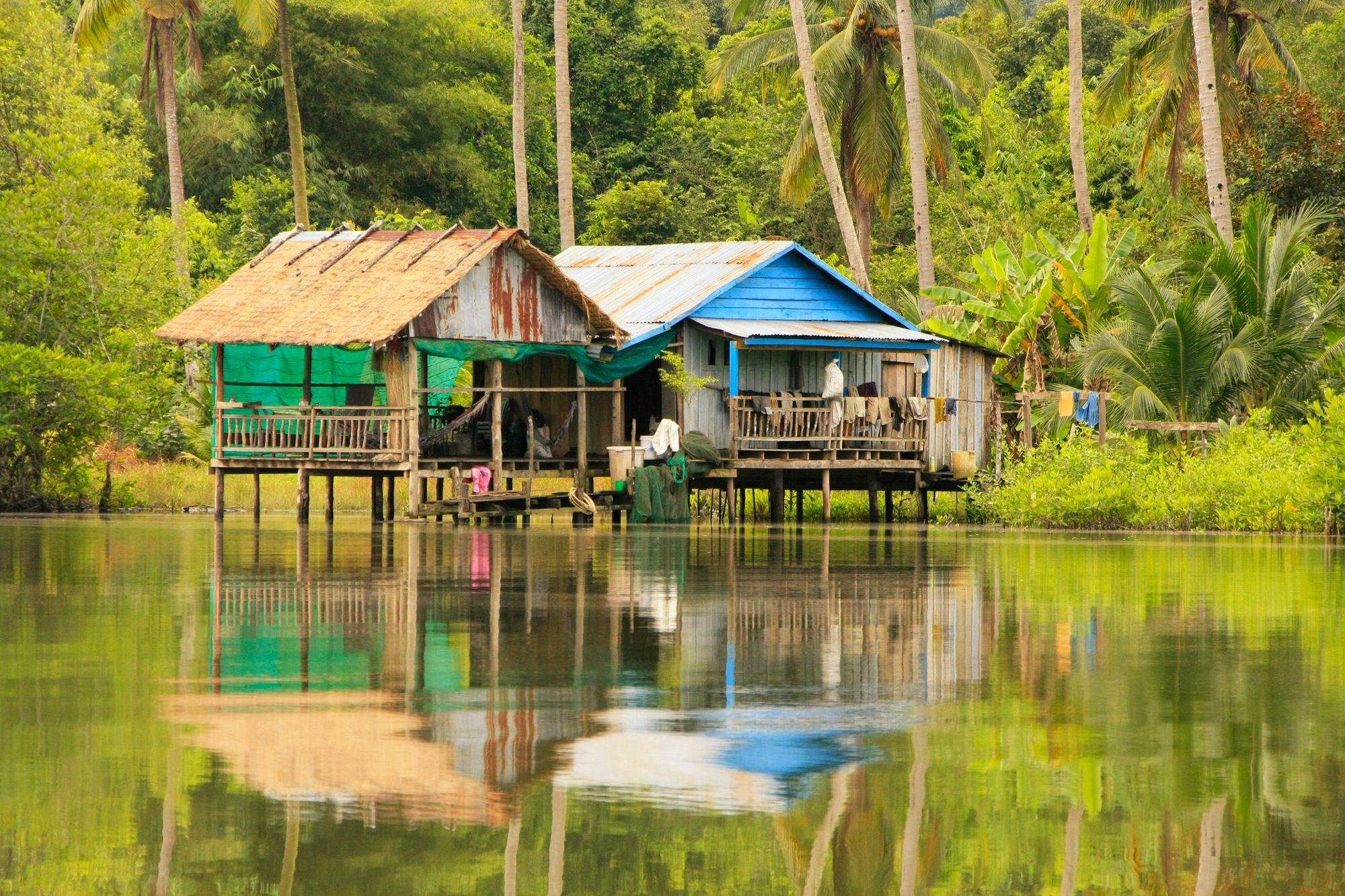 A pair of houses on stilts in Ream National Park in Cambodia. Photo: Getty