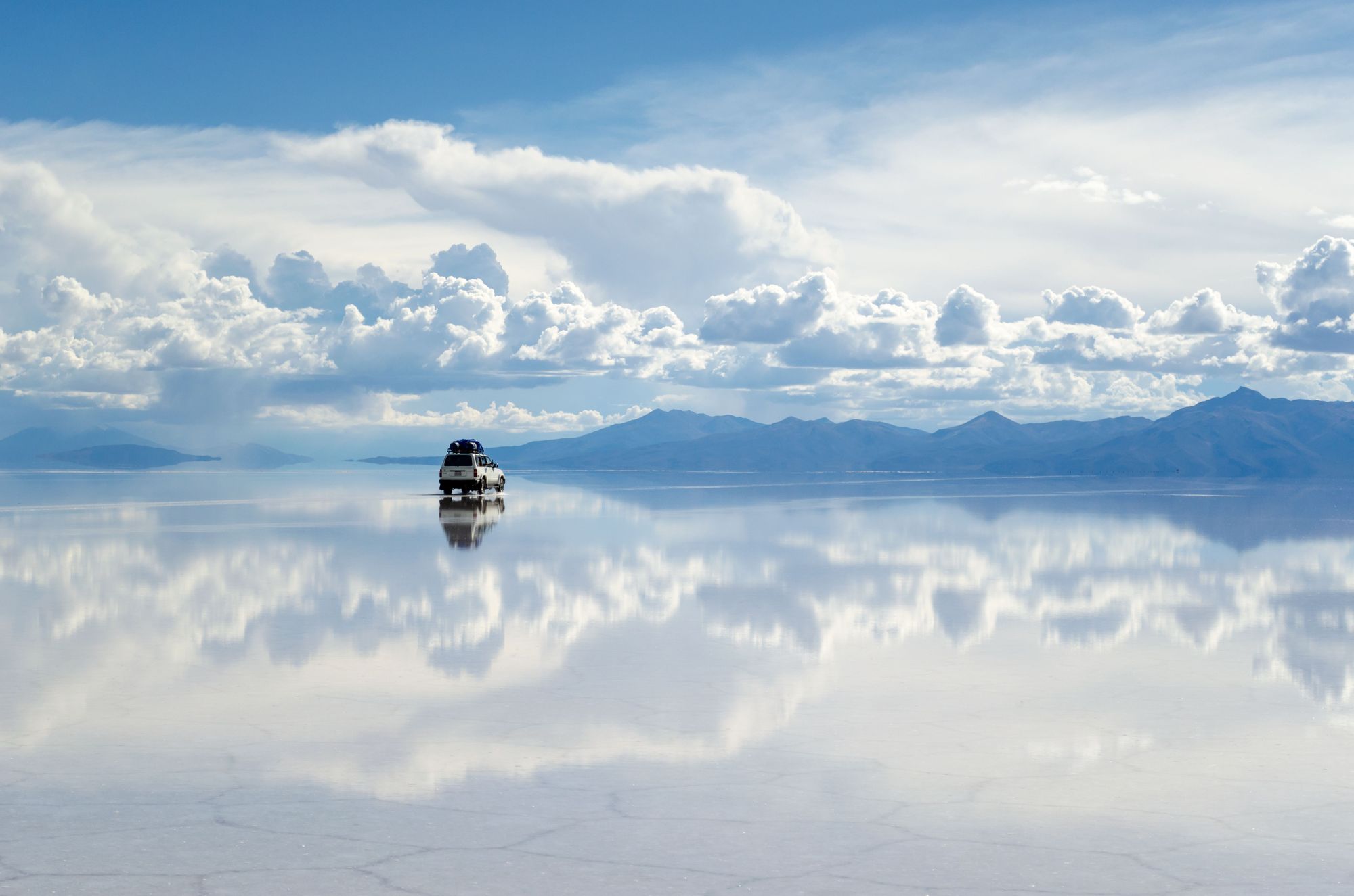 A car drives across the Salar de Uyuni in Bolivia, the largest expanse of salt flats in the world. Photo: Getty