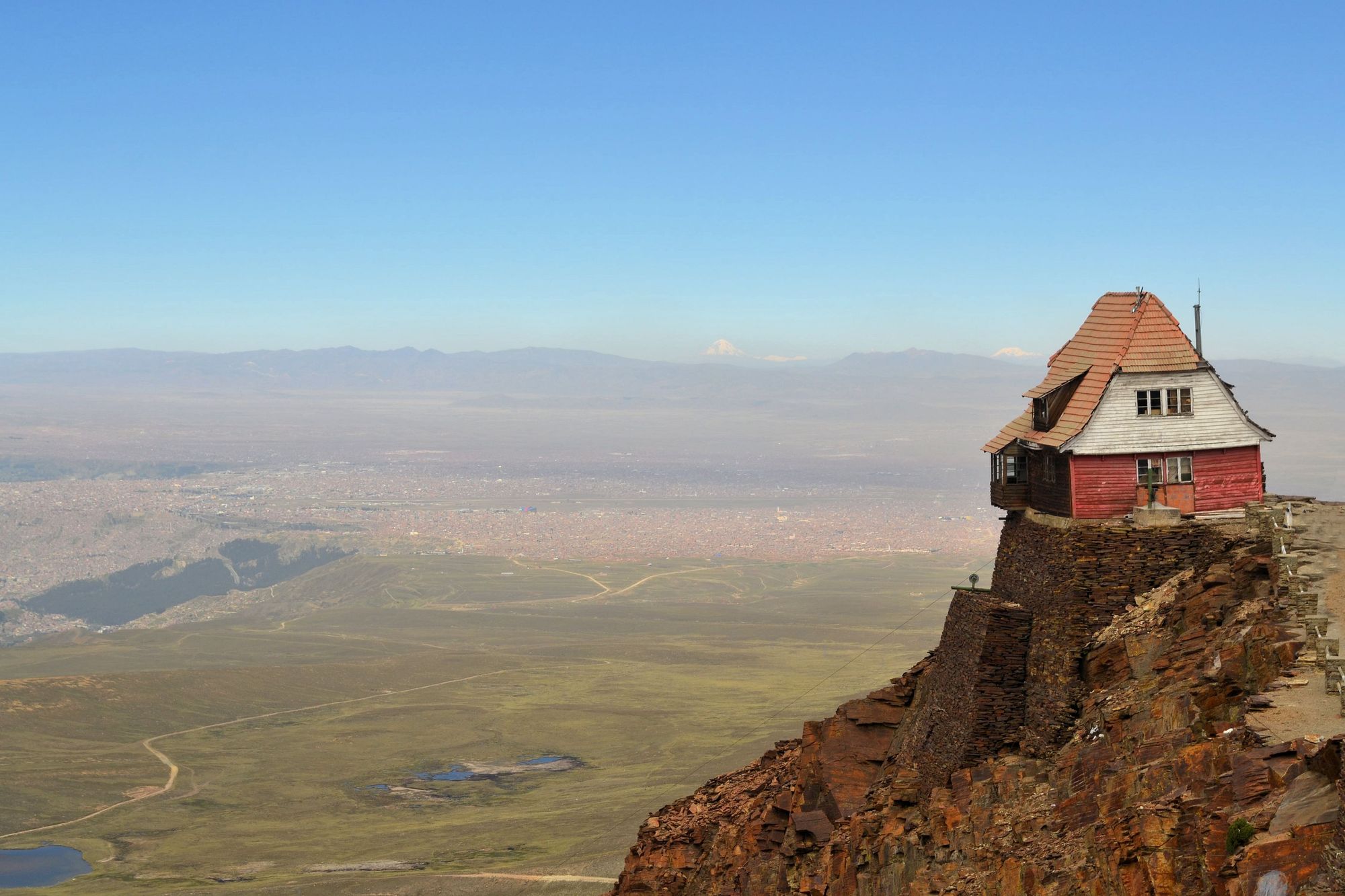 A wobbly house perched on the edge of a mountain peak. It was part of the ski resort once housed beneath Chacaltaya, in Bolivia. Photo: Getty