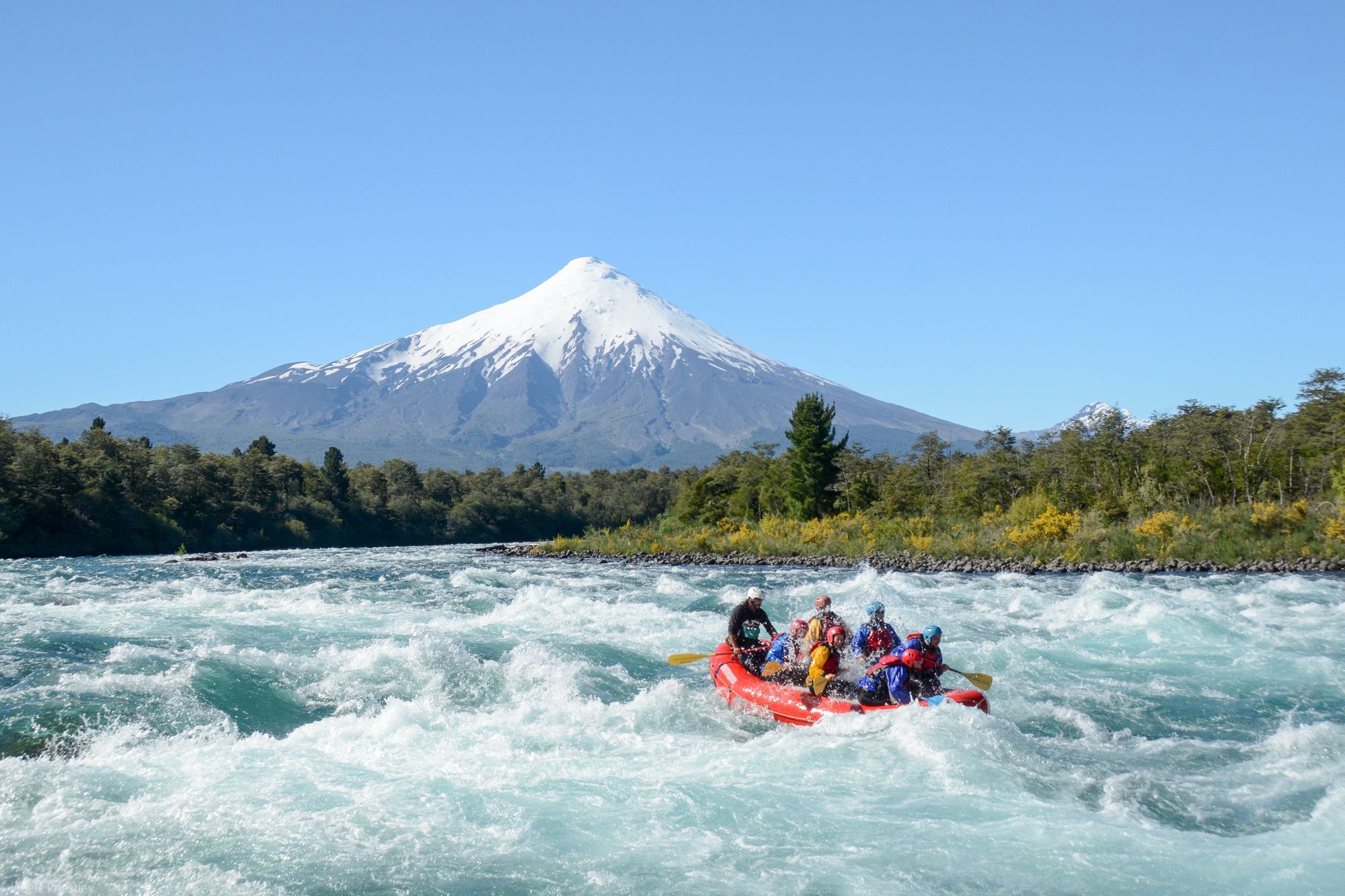 White water rafting near Puerto Varas, looking onto Osorno volcano which rises from Lake Llanquihue, Chile's second largest lake. Photo: Birds Chile
