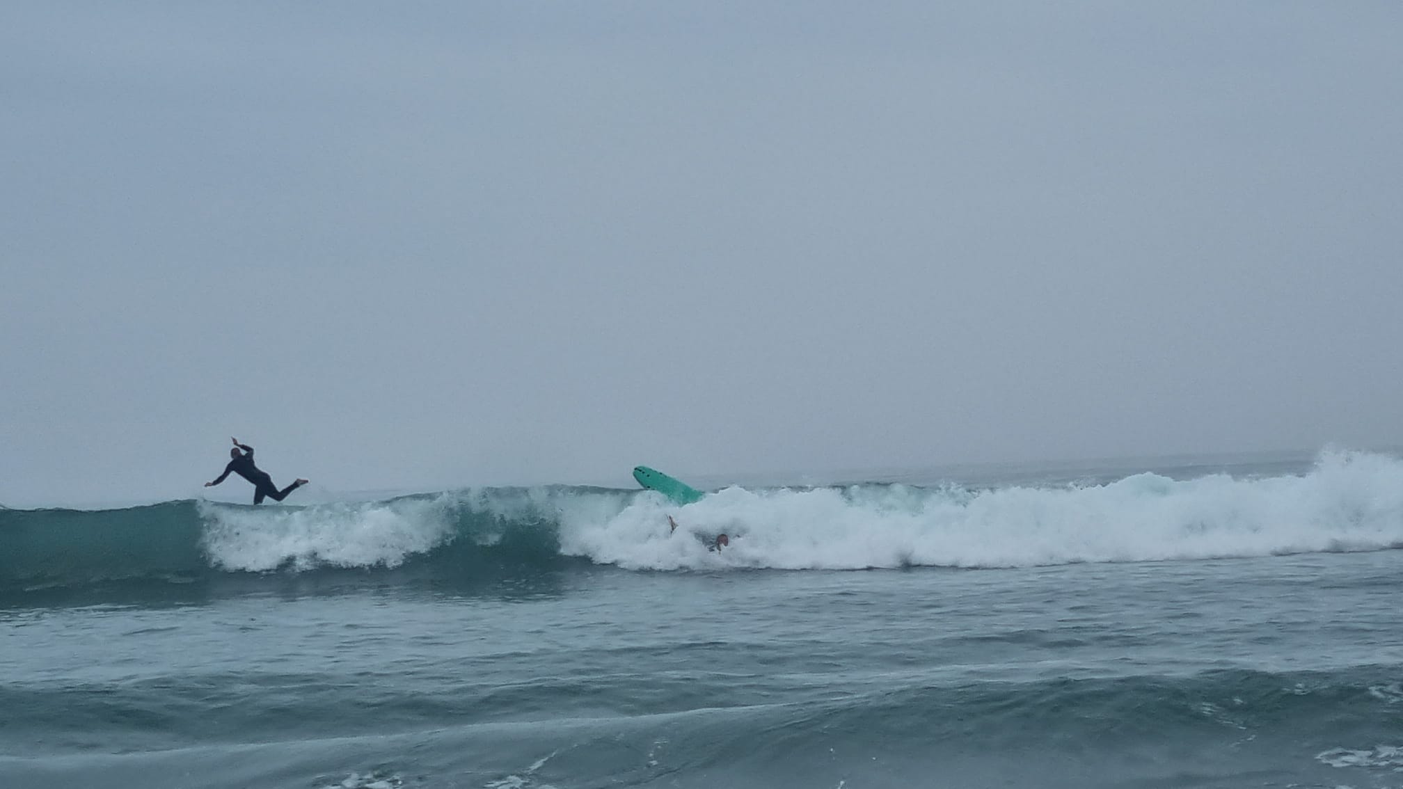 Two surfers wiping out