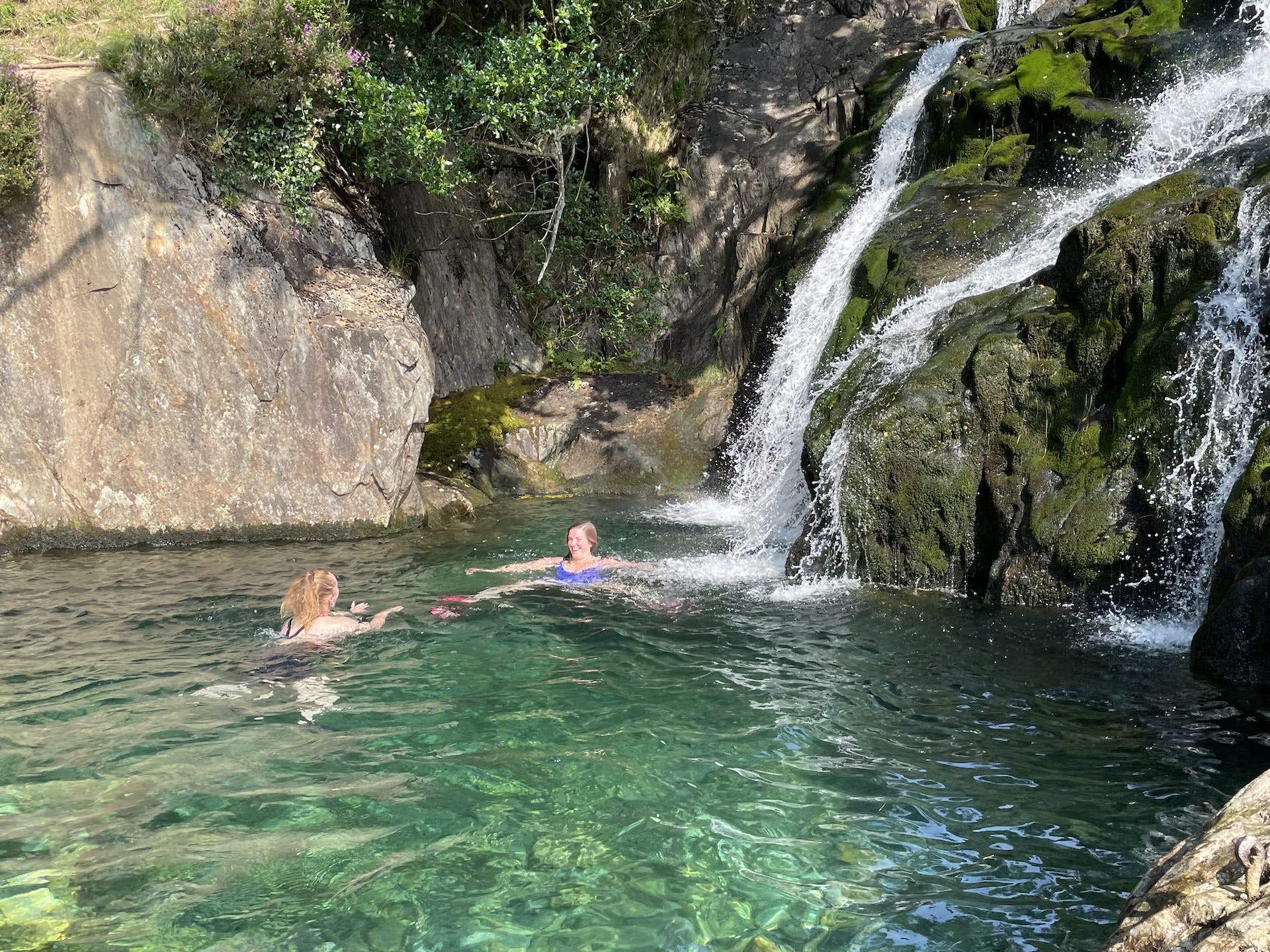 Two swimmers take a dip at Llyn Dinas, a small pool in Snowdonia. Photo: Adventurous Ewe