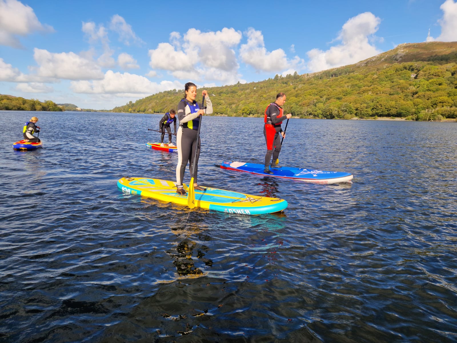A group learning to SUP on Llyn Padarn, a lake in Snowdonia. Photo: Adventurous Ewe.