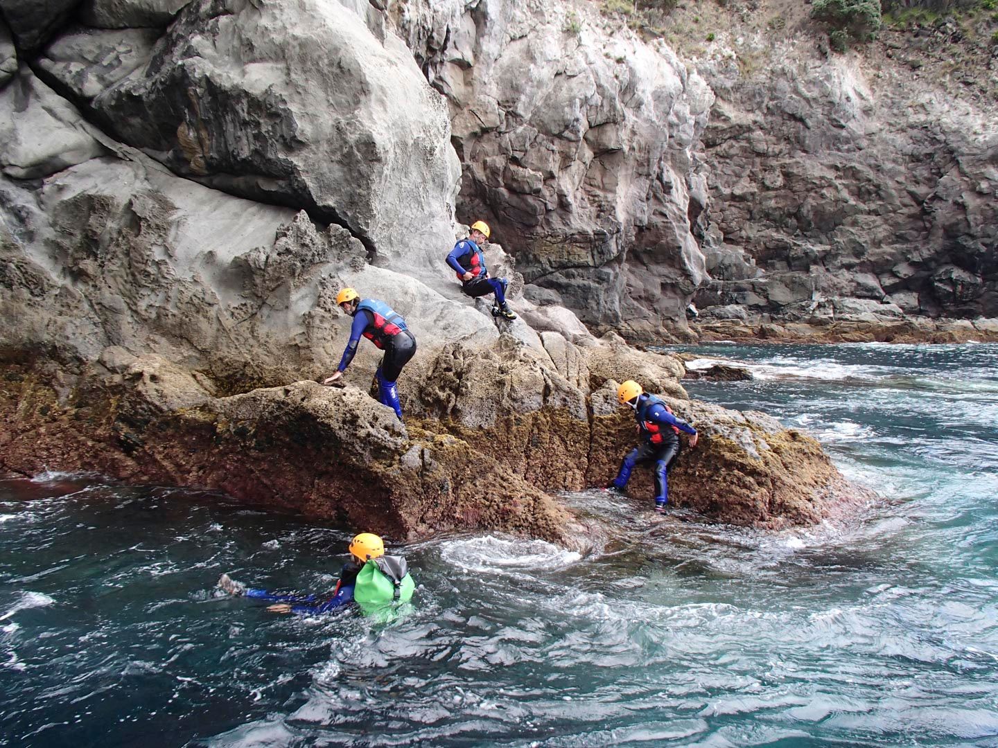 A group of people coasteering in the Azores