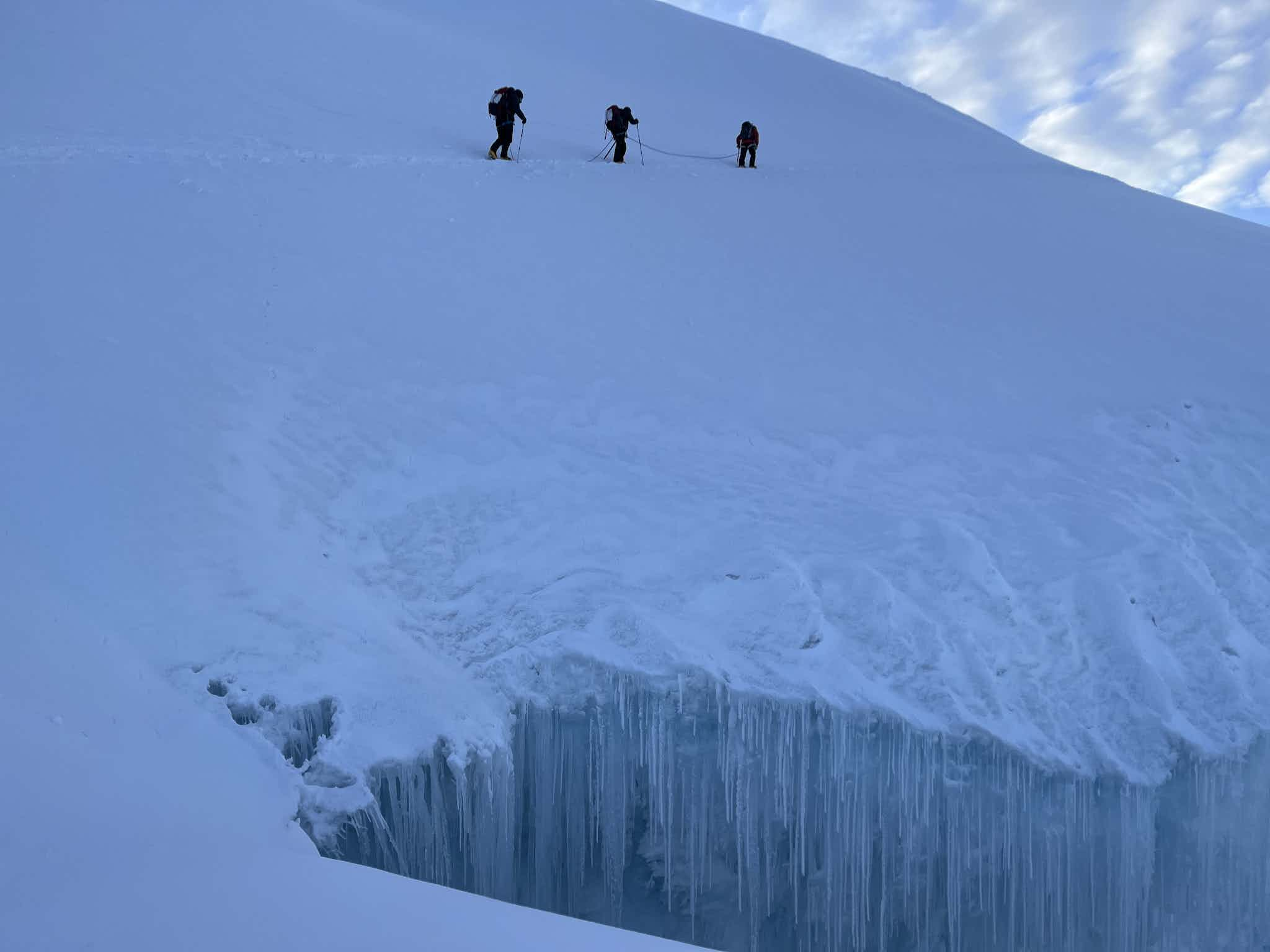 Hikers on a snow encrusted mountain in Ecuador