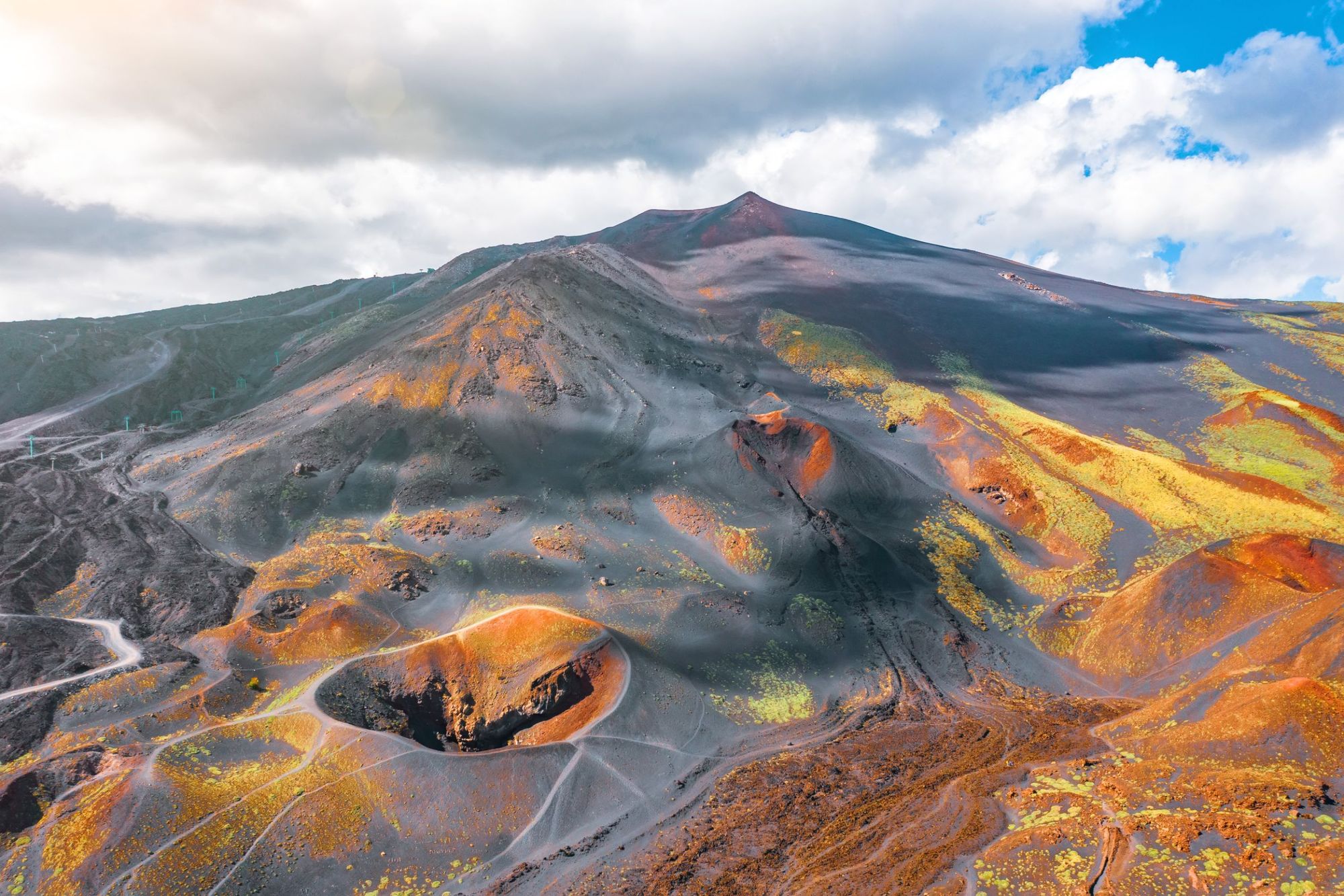 The multi-coloured moonscapes of Mount Etna, visible on the summit hike. Photo: Getty