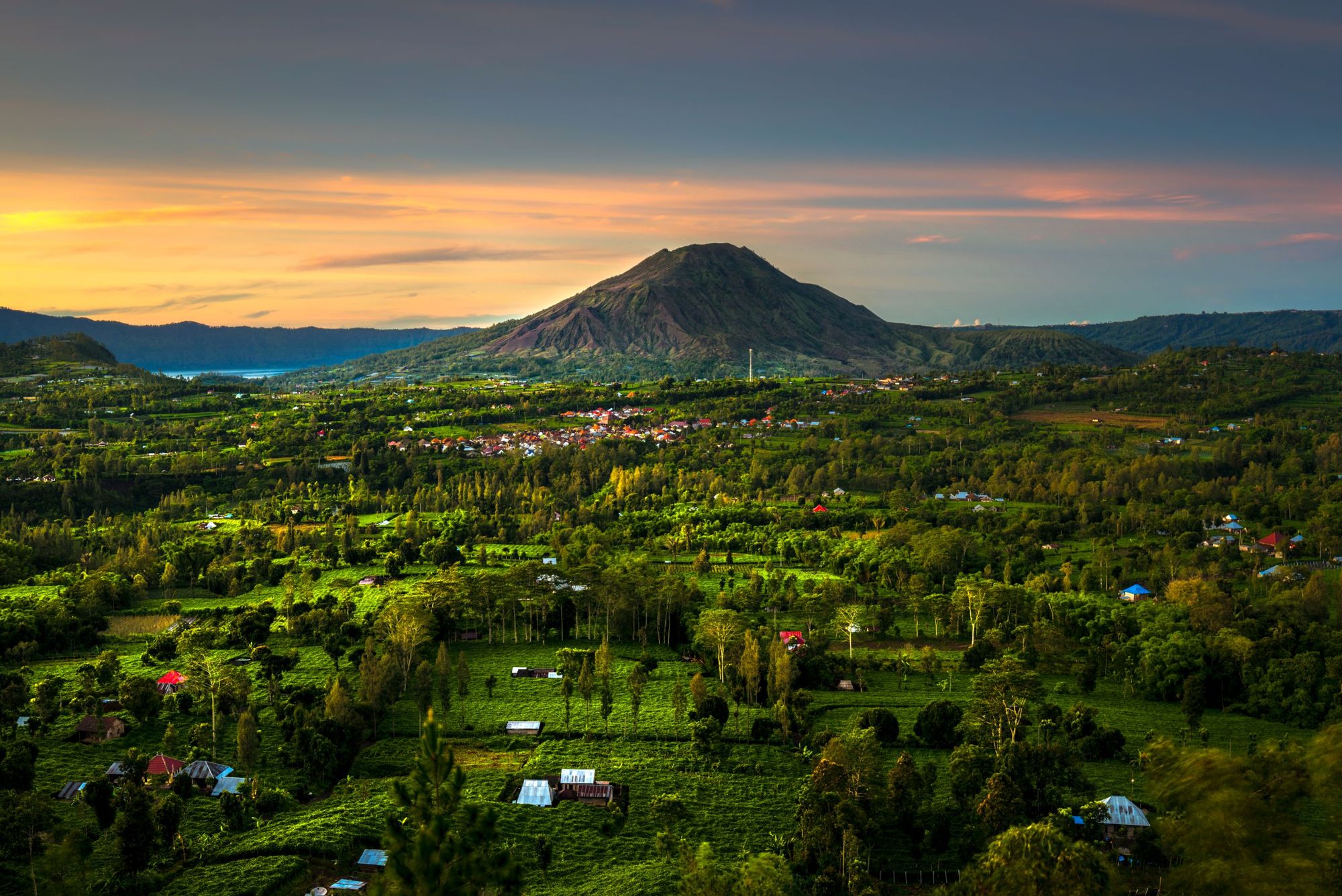 The bulk of Gunung Batur, and the beautiful green countryside below, on the island of Bali. Photo: Getty