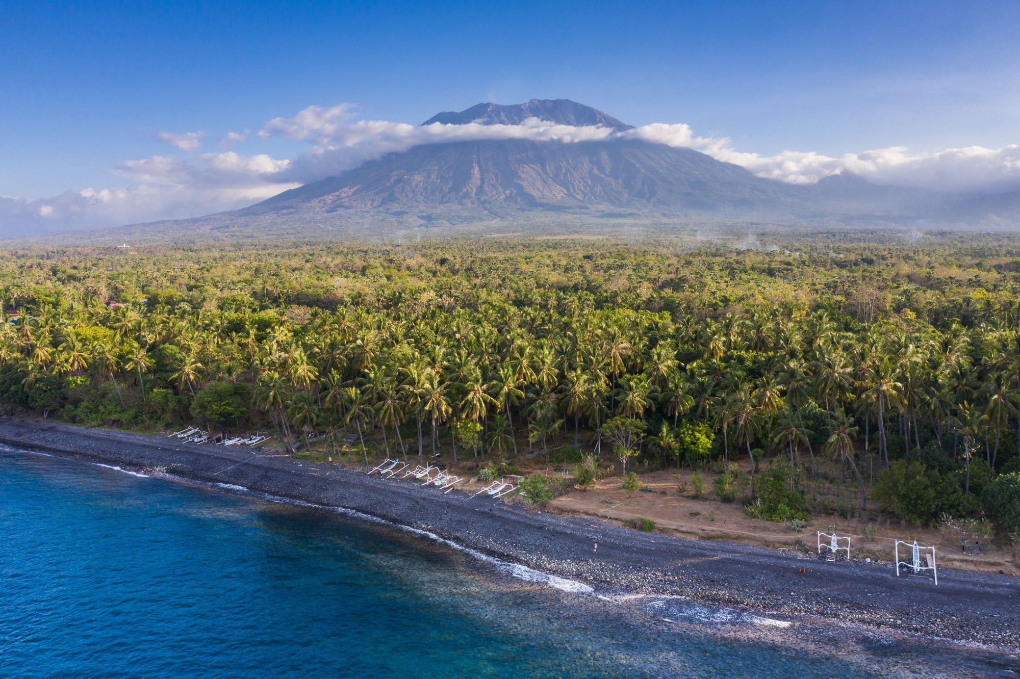 The enormous Ganung Agung, the high point of Bali, backdropping a dense coastal forest. Photo: Getty