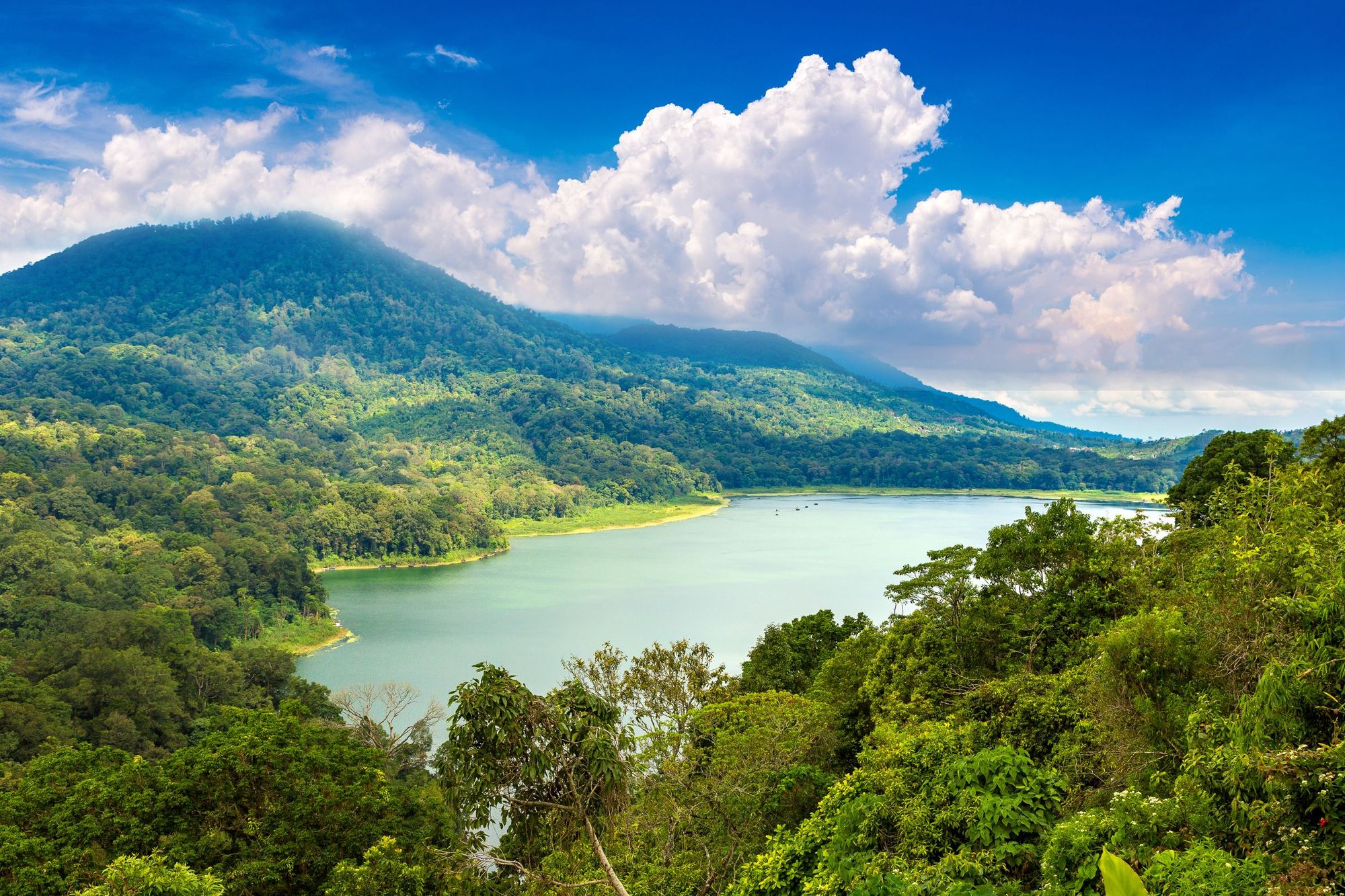 The sun shines on Danau Tamblingan, a stunning lake right next to Danau Buyan, in Bali. Photo: Getty