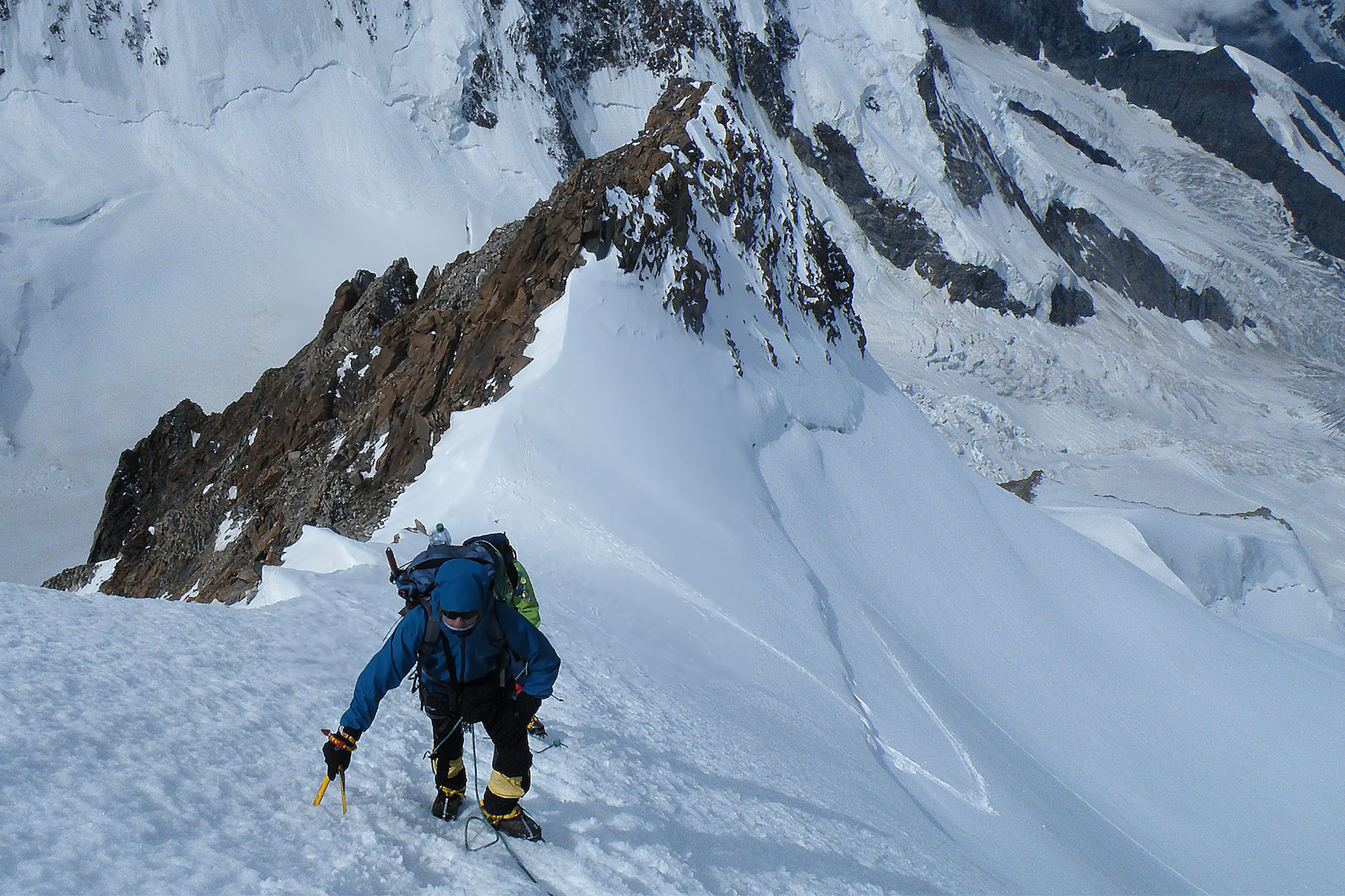 Roped climber on a snowy ridge of Monte Rosa