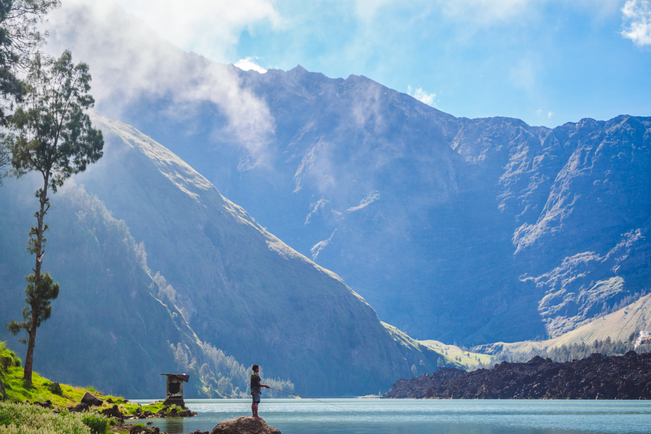 A fisherman on the shore of Segara Anak, a crater lake on Mount Rinjani.