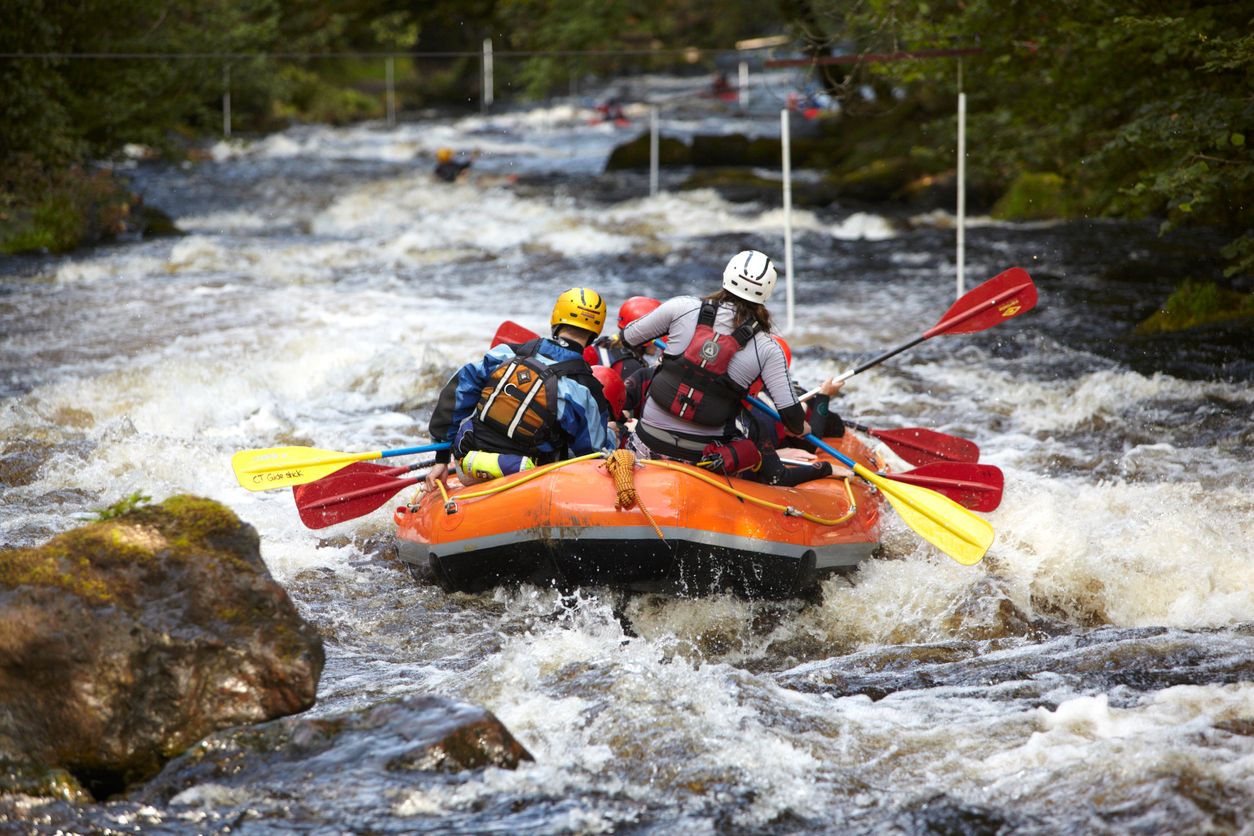 A white water rafting group negotiates a rapid on the River Tryweryn, Bala, North Wales. 
