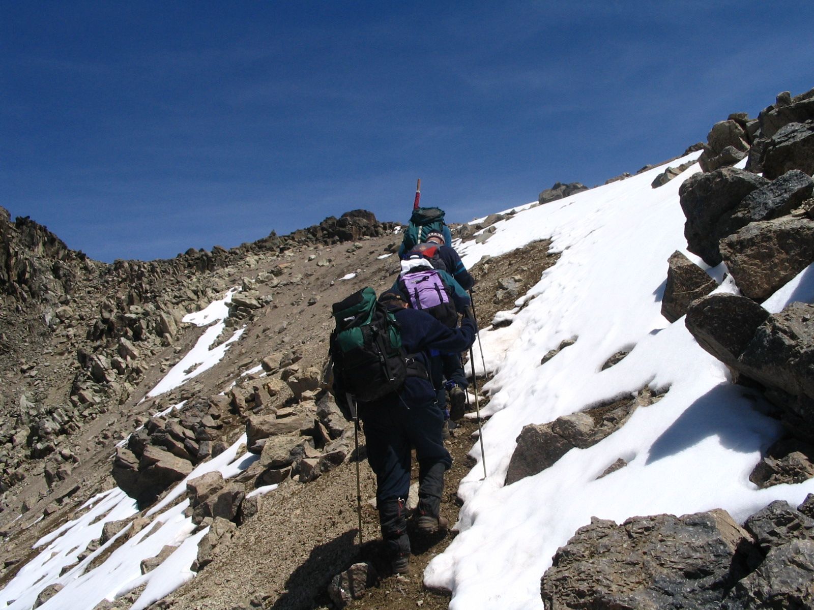 A group of hikers ascend the high, loose gravel slopes on Mount Kenya. Photo: Getty