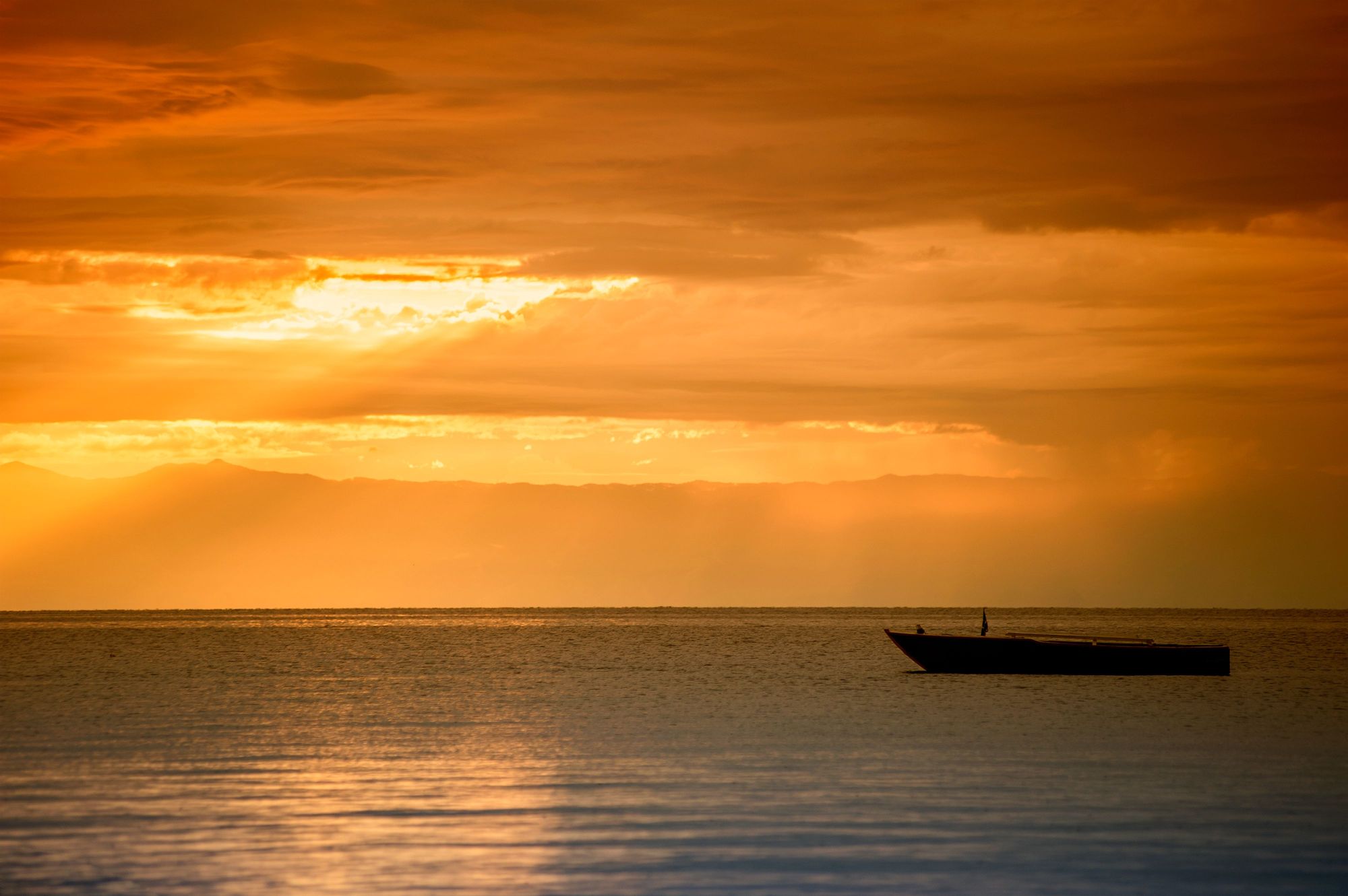 A typical wooden boat in the last daylight at Lake Tanganyika. Photo: Getty