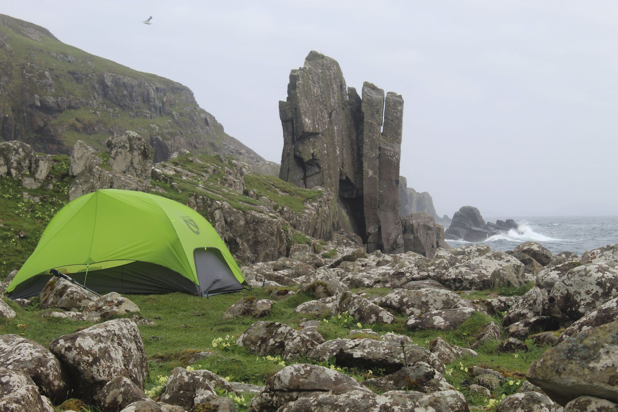 A scenic tent pitch on the west of the Isle of Rùm, beneath the stone of the Papadil stack. Photo: Stuart Kenny