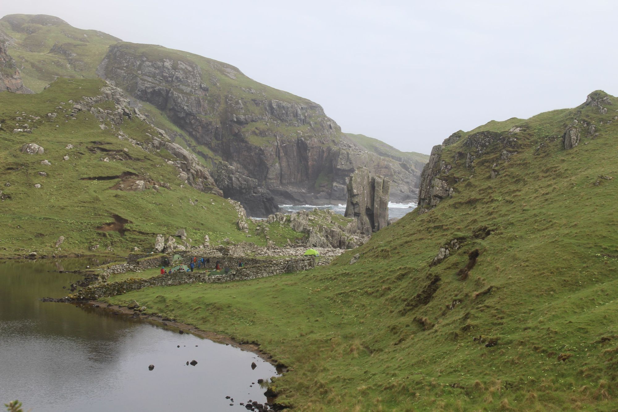 The entrance to Papadil is a scenic trail with a loch on the left, an old settlement in the centre and the sea stack and coastline beyond. Photo: Stuart Kenny