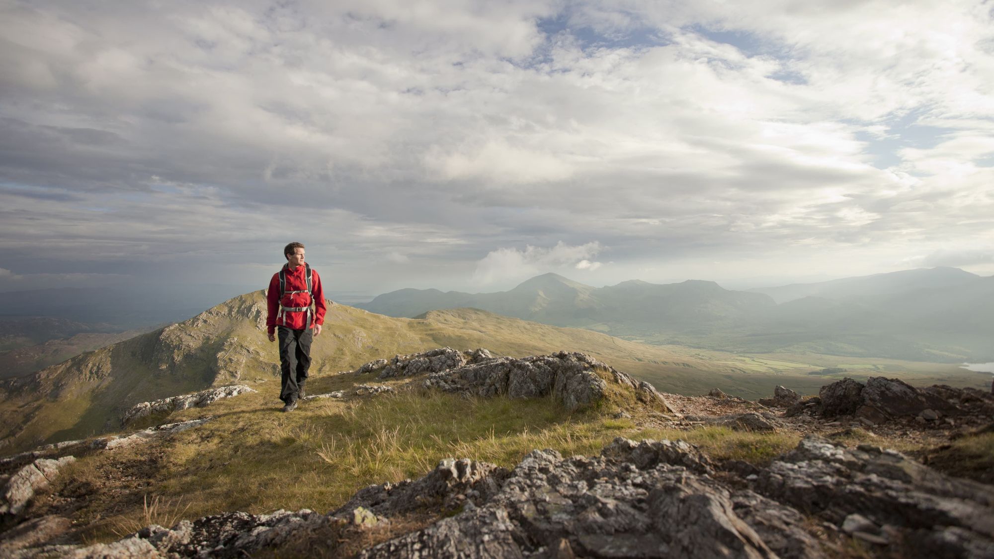 A man walking on the mountain tops of Snowdon