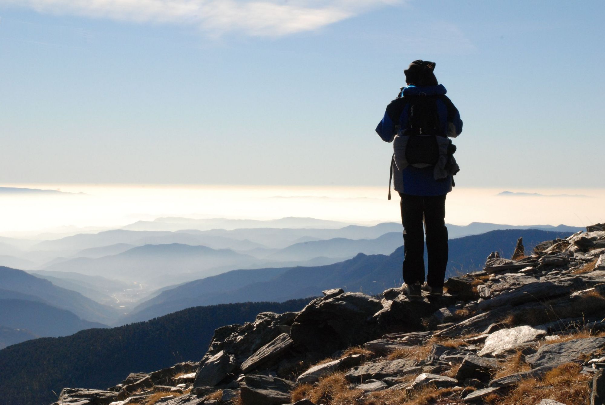 A hiker on top of Puigmal, in the Spanish Pyrenees