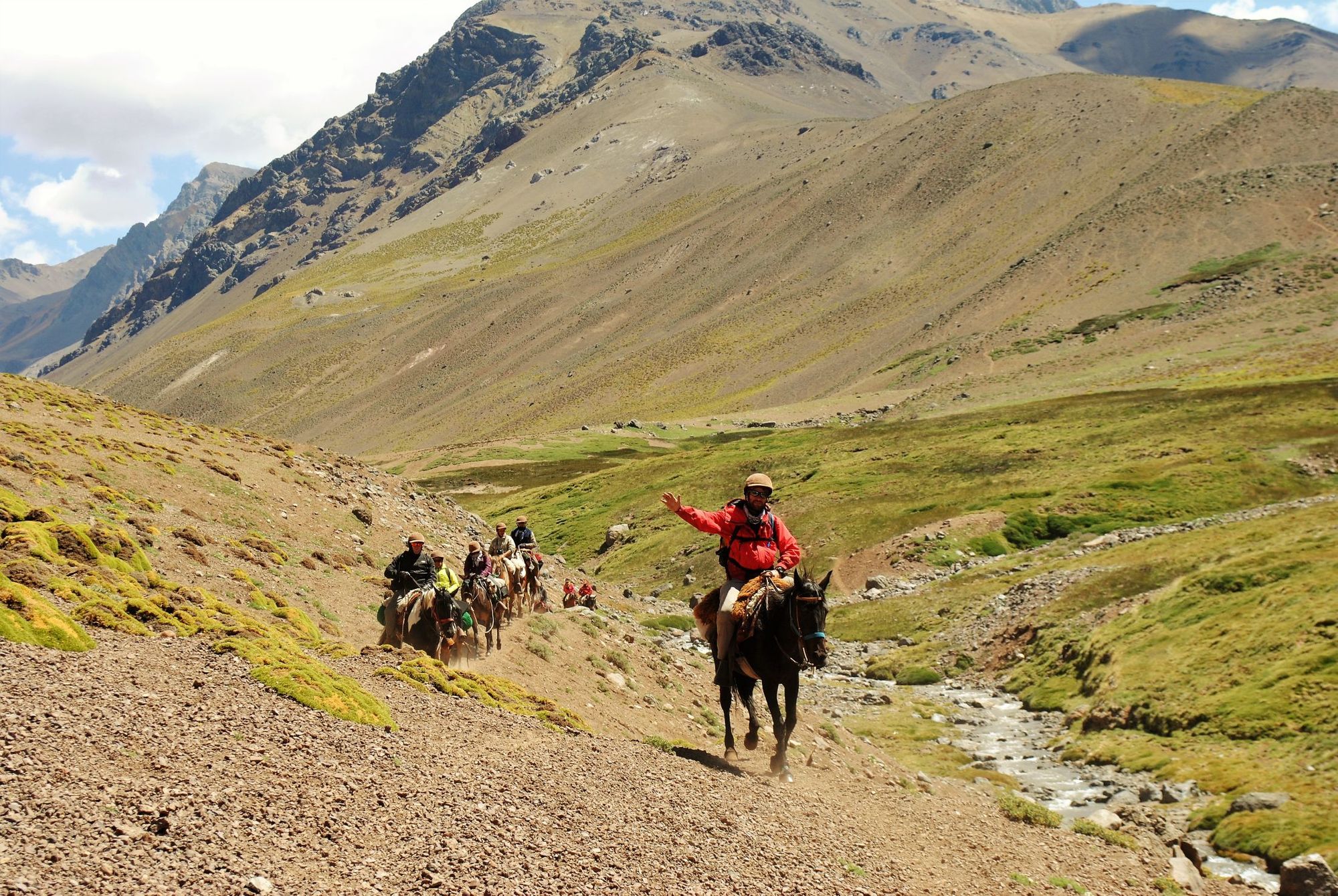 Horsemen crossing the Andes, carrying gear.