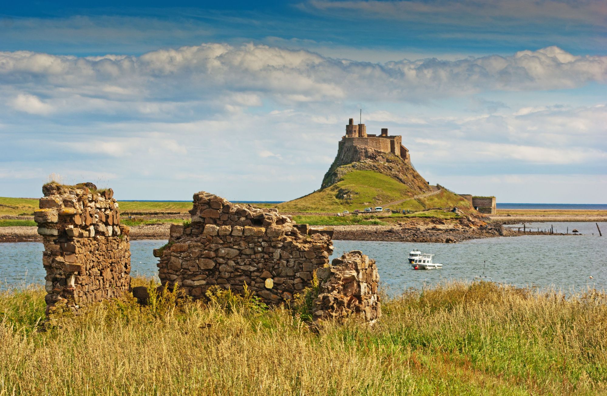 A view of Lindisfarne Castle on the Holy Isle in Northumberland, against a pale summer sky. Photo: Getty