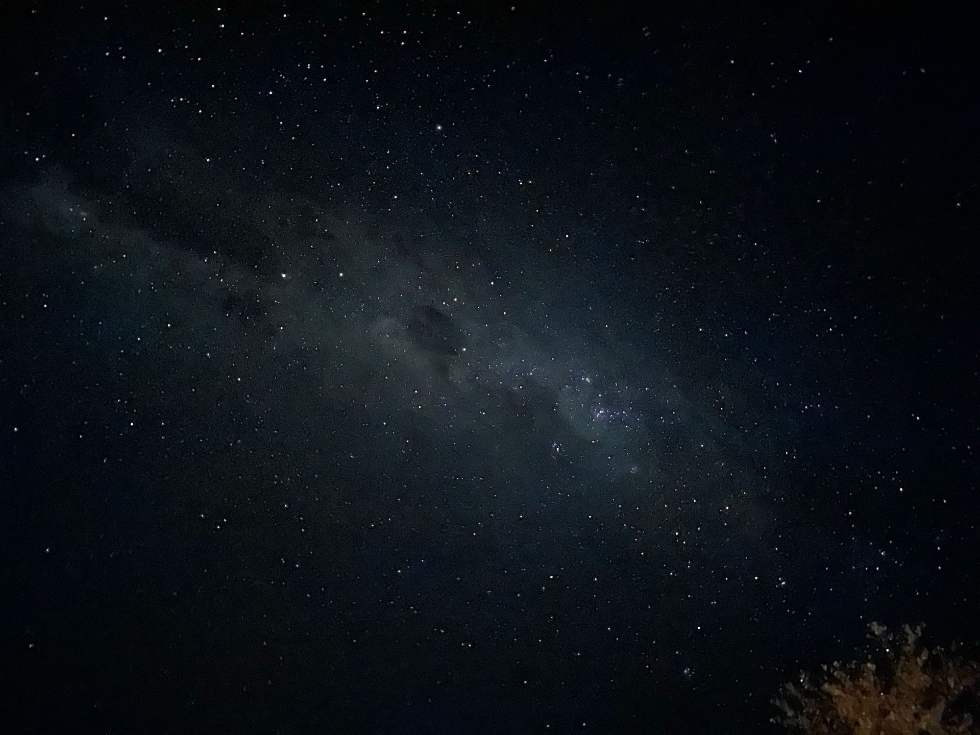 The night sky studded with stars, Milky Way at the centre.