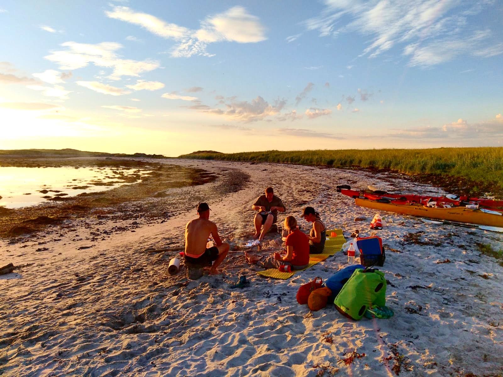 Setting up camp on a secluded beach at sunset in the Lofoten Islands. Photo: Northern Explorer.