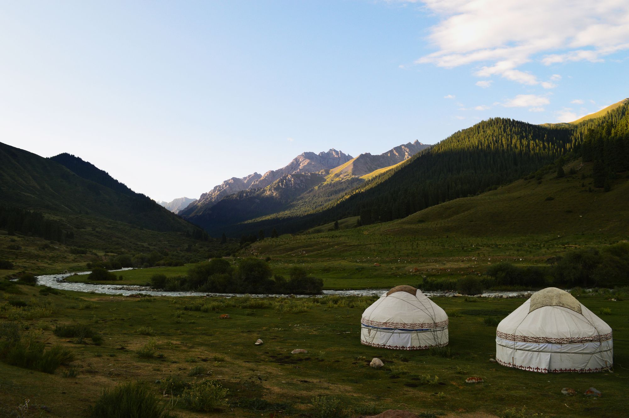 Yurts by the river in Kyrgyzstan.