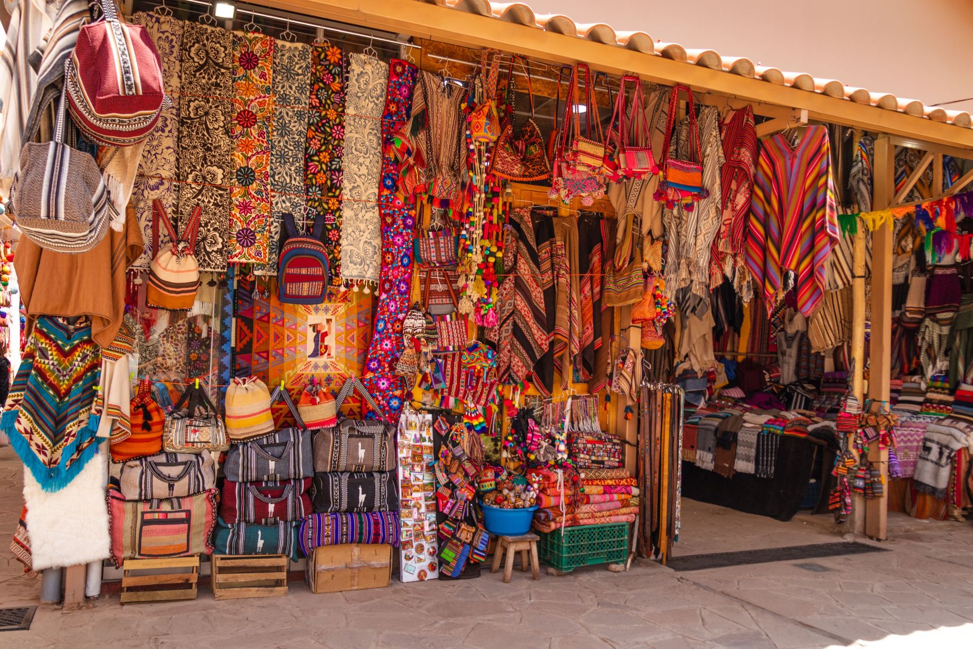 Souvenirs at the Pisac artisan market, from ponchos to blankets and satchels. Photo: Getty
