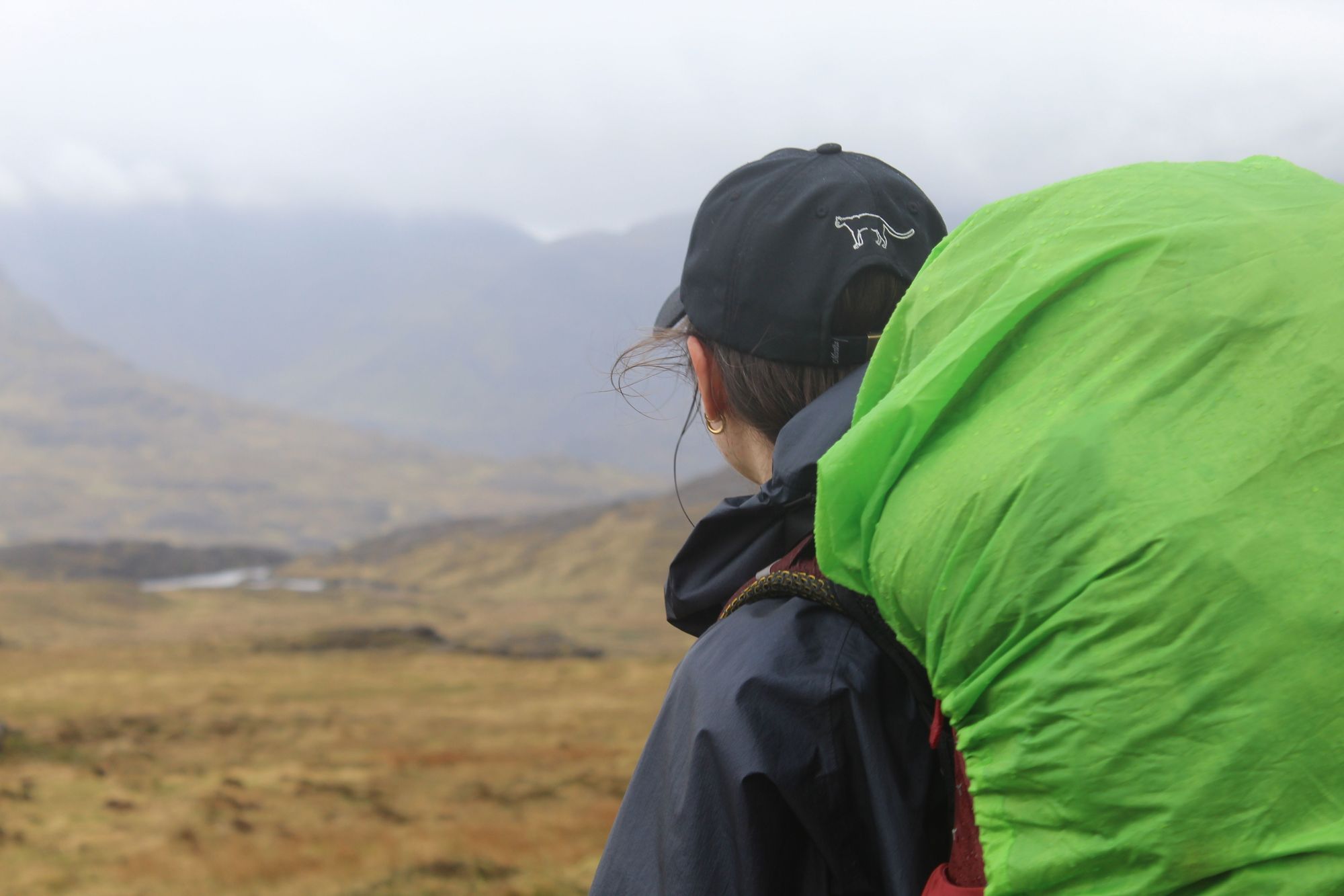 A woman looks out on a Scottish Highland landscape, on the island of Rum. Photo: Stuart Kenny
