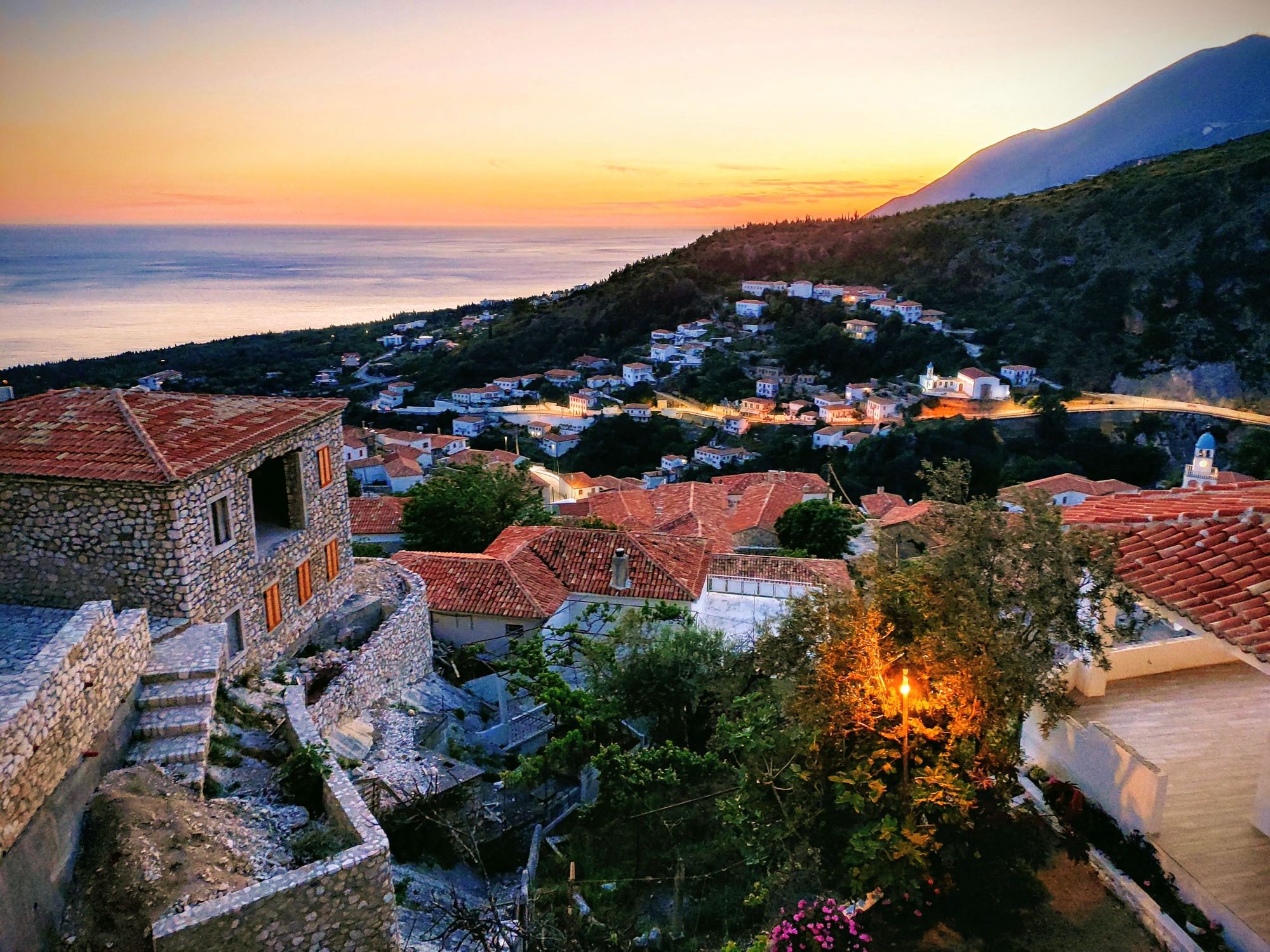 The sun sets over the old stone houses of Dhërmi on the Albanian Rivieria. Photo: Ricardo Fahrig