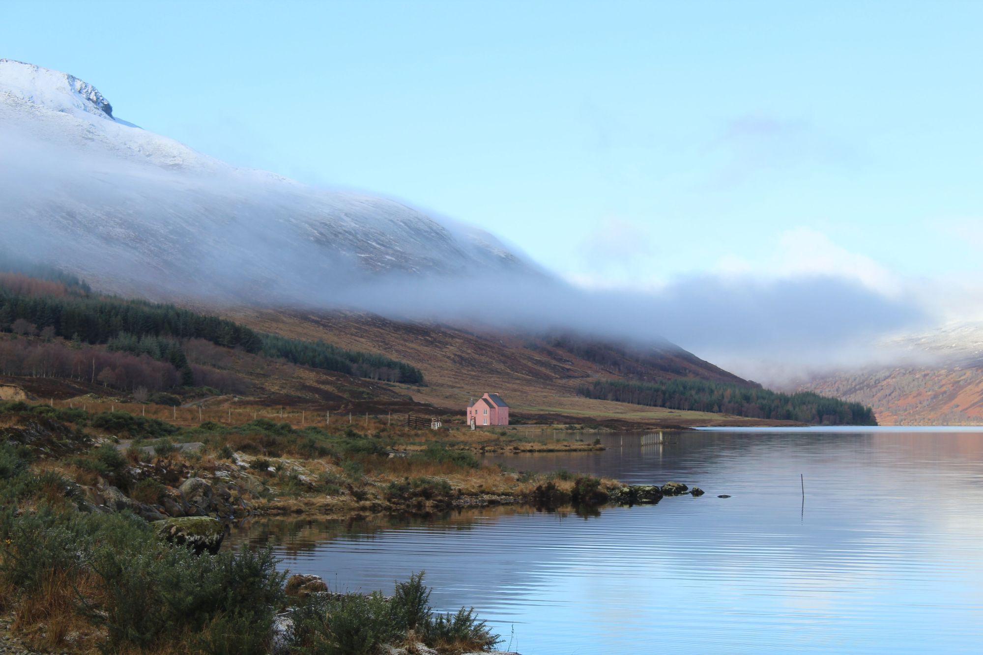 The mist hits Loch Glass, and rolls above the Pink House, on the edge of the water. Photo: Stuart Kenny