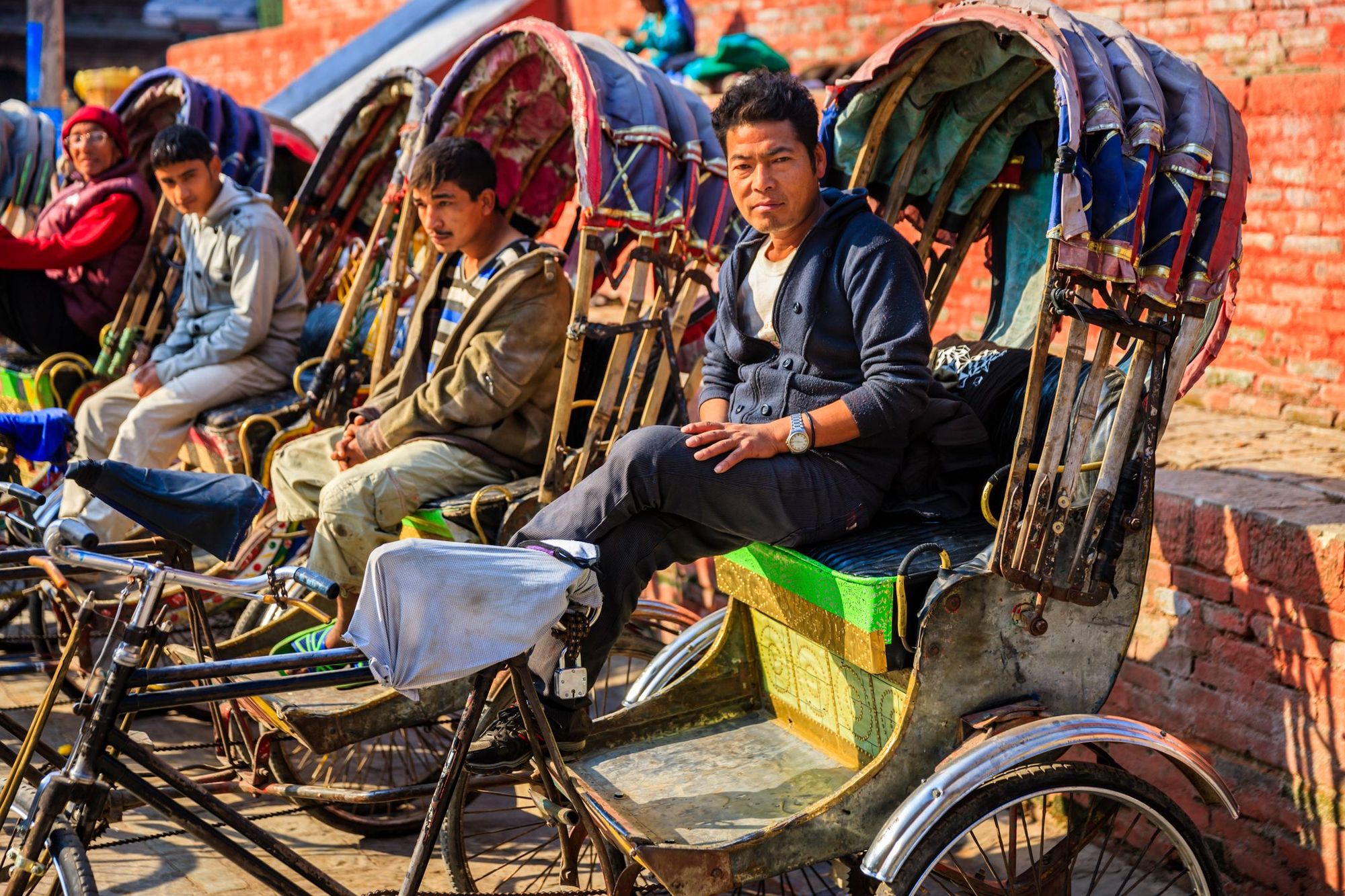 Cycle rickshaw drivers waiting for passengers. Photo: Getty.