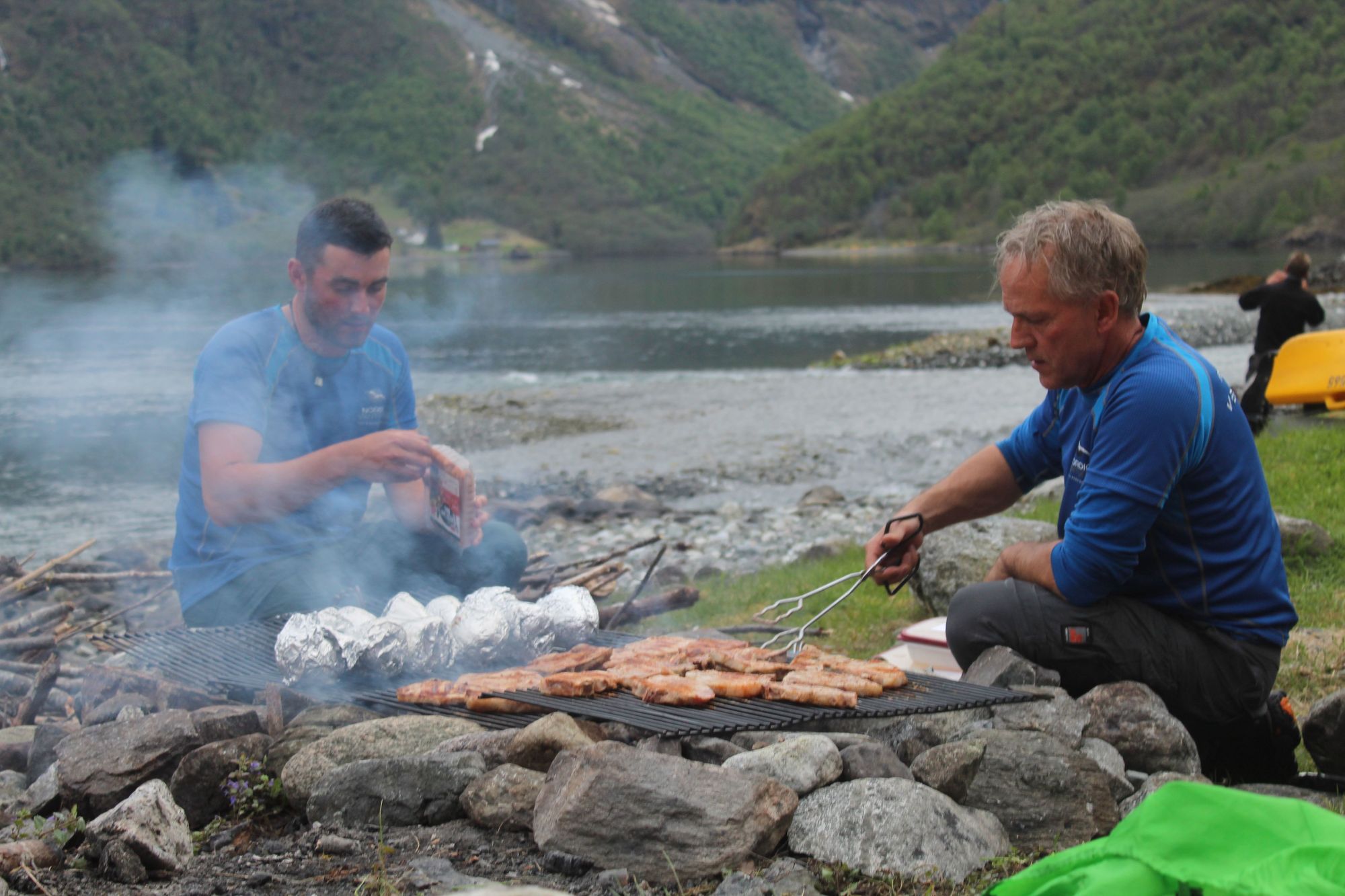 Jan and fellow guide Jordan grilling dinner on the edge of the fjord. Photo: Stuart Kenny