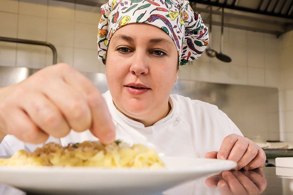 Chef Elisa puts the finishing touches on a dish at La Bella Follina, an agriturismo in Italy . Photo: Elisa Ceccato