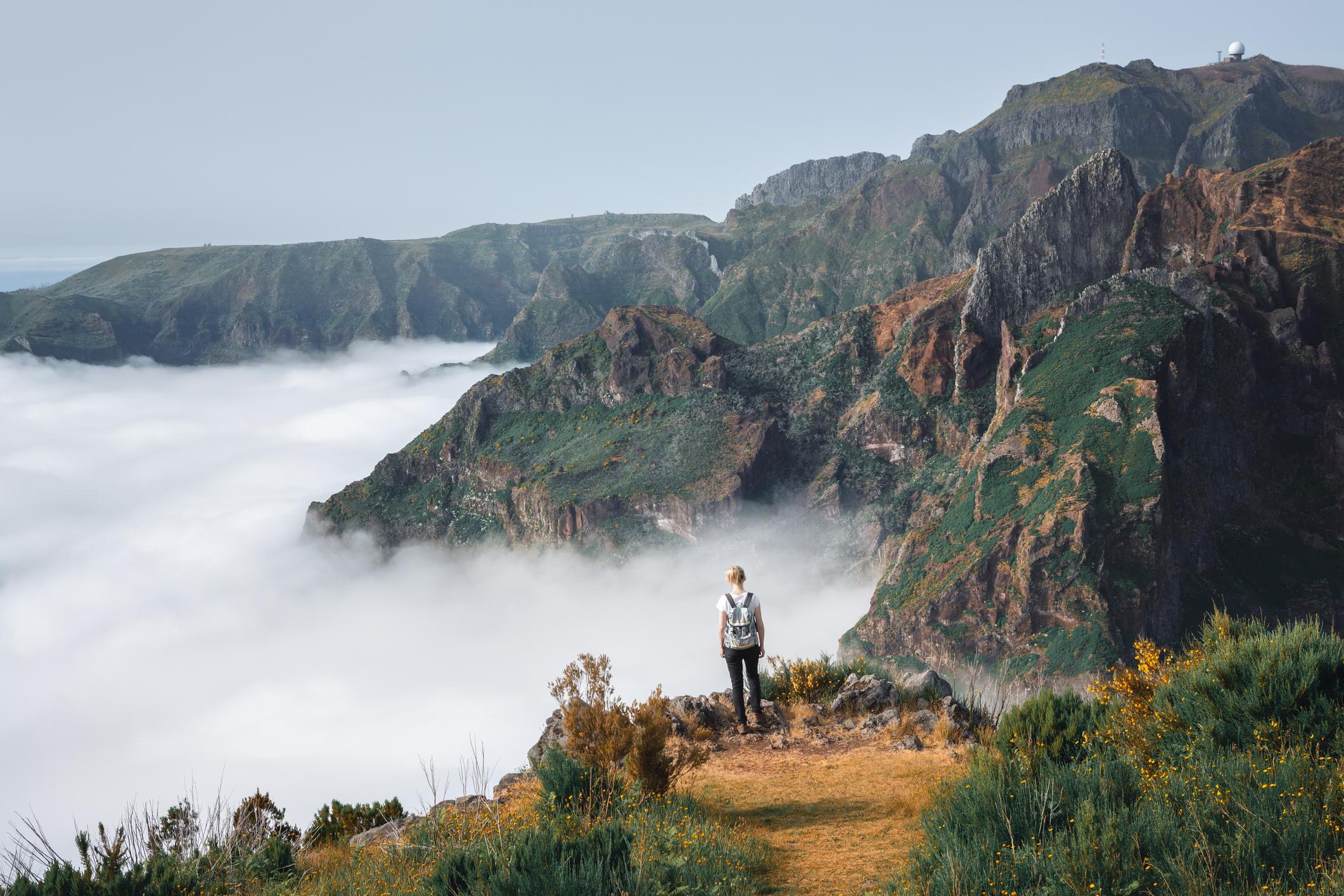 A hiker looks out over the mountains in Madeira