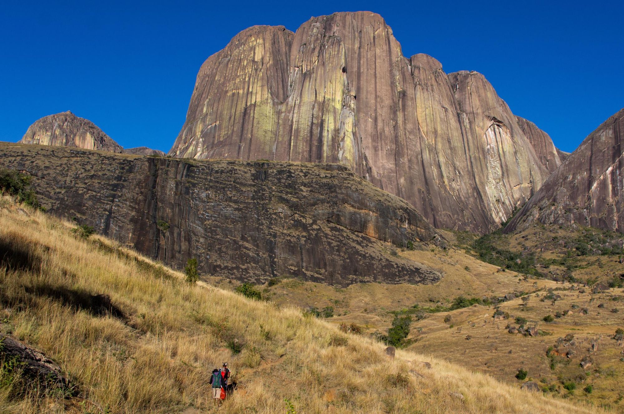 Hikers below Tsaranoro Cliff, Madagascar