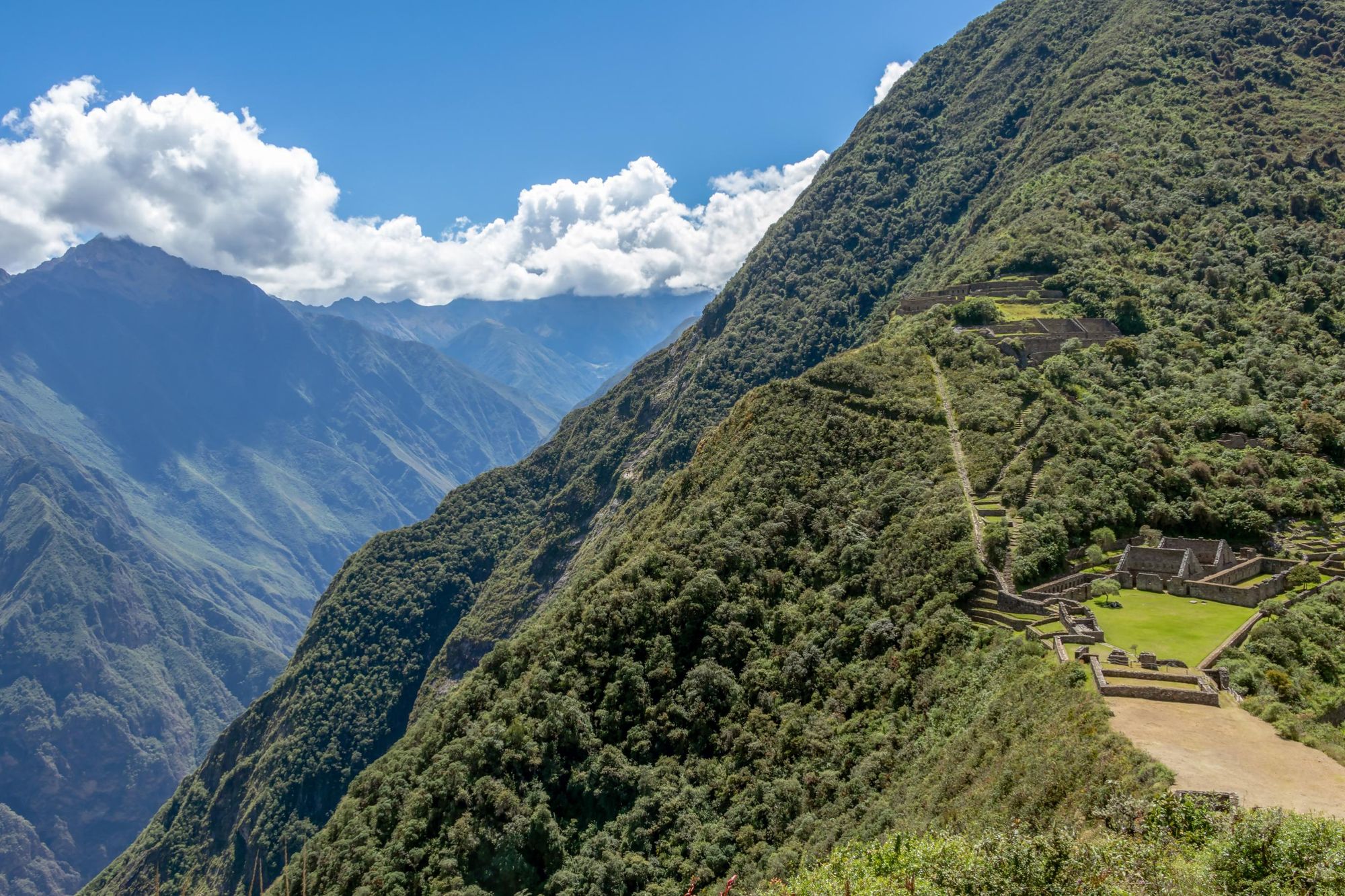 The site of Choquequirao is perched on a mountain slope with sensational views out over the surrounding mountains. Photo: Getty