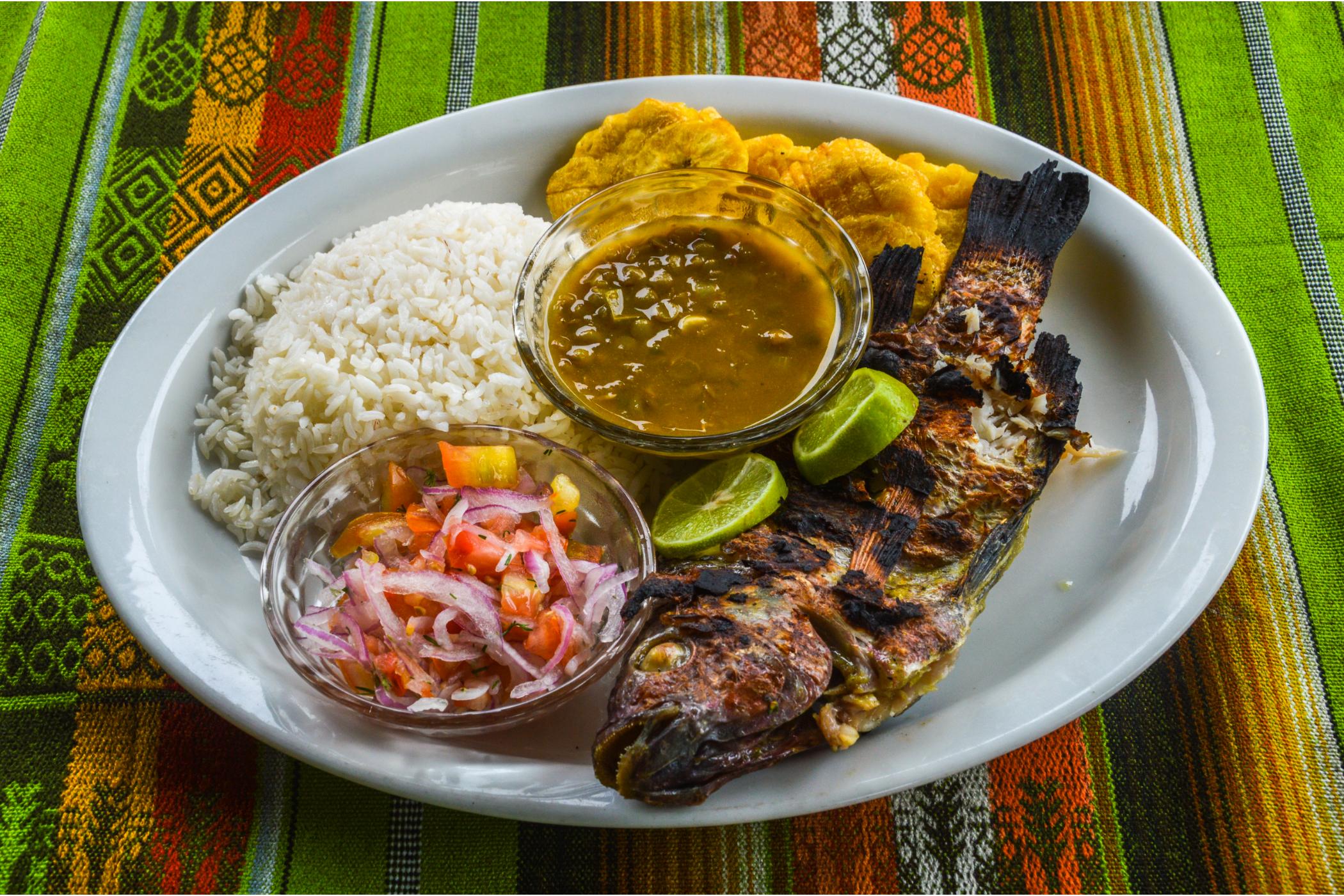 An Ecuadorian meal of grilled fish, plantains and rice. Photo: Canva.