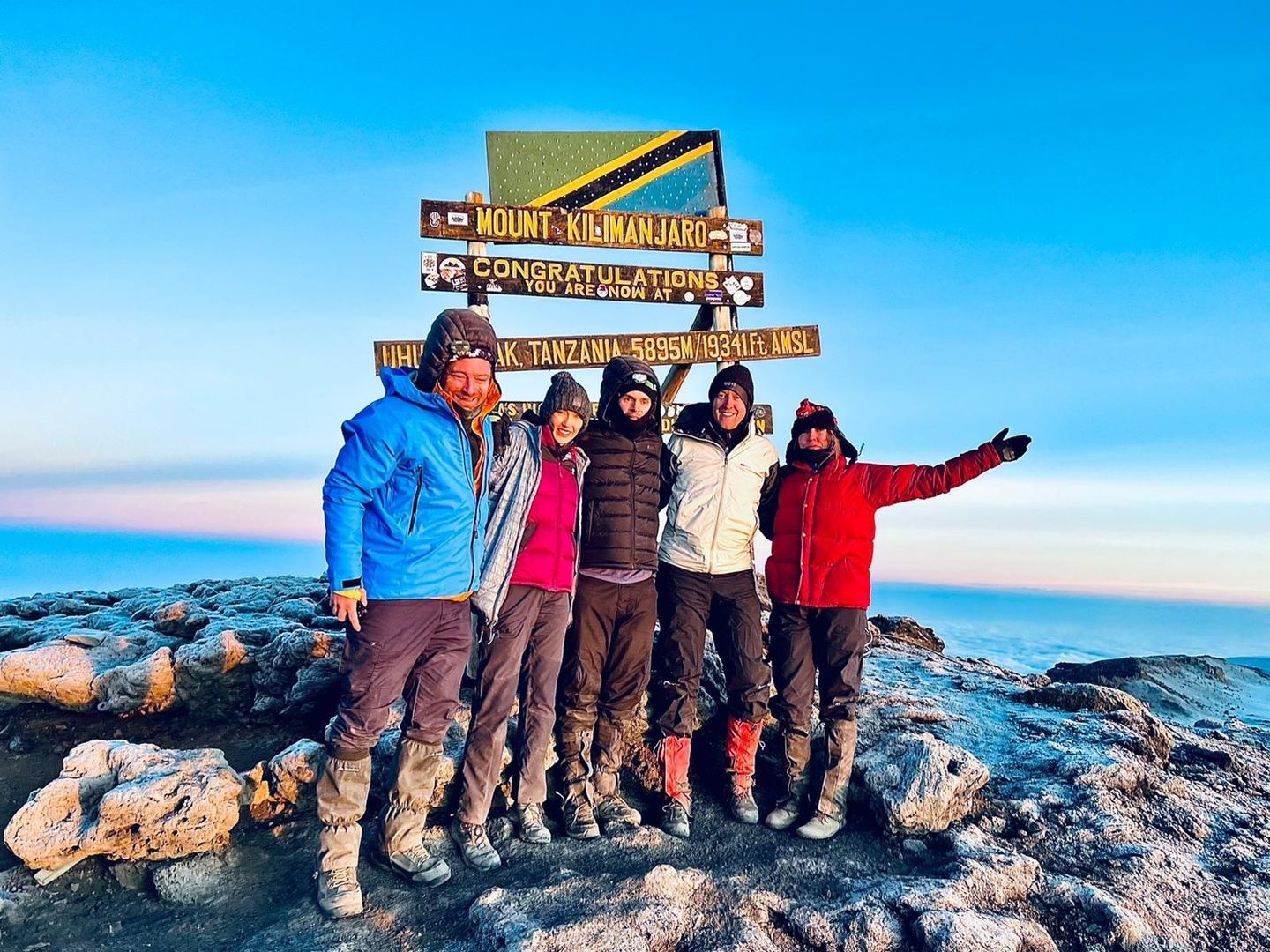 A group of Much Better Adventurers pose at the top of Kilimanjaro. Photo: Trek 2 Kili